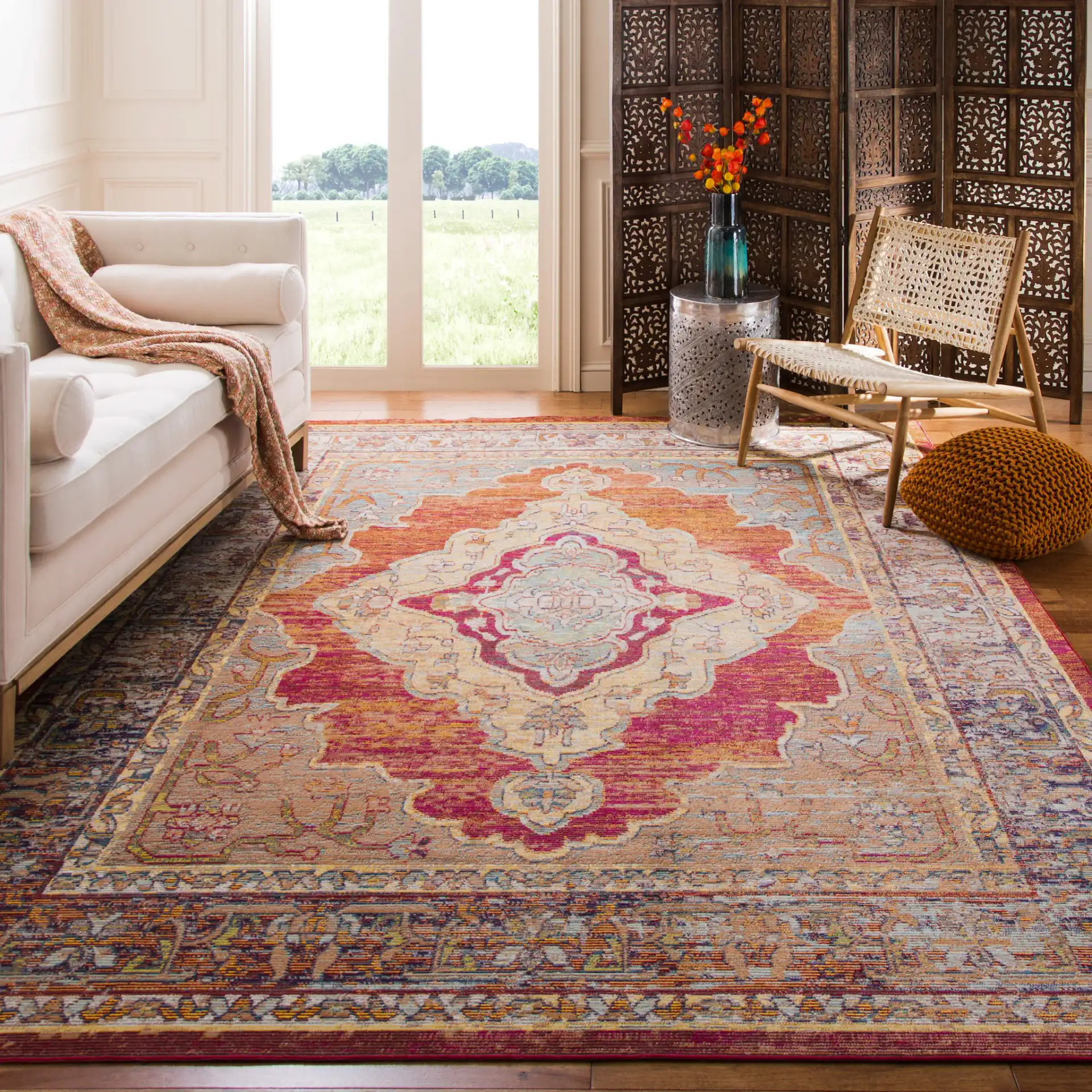 Crystal Medallion Bordered Rug in Orange / Light Blue in a styled room