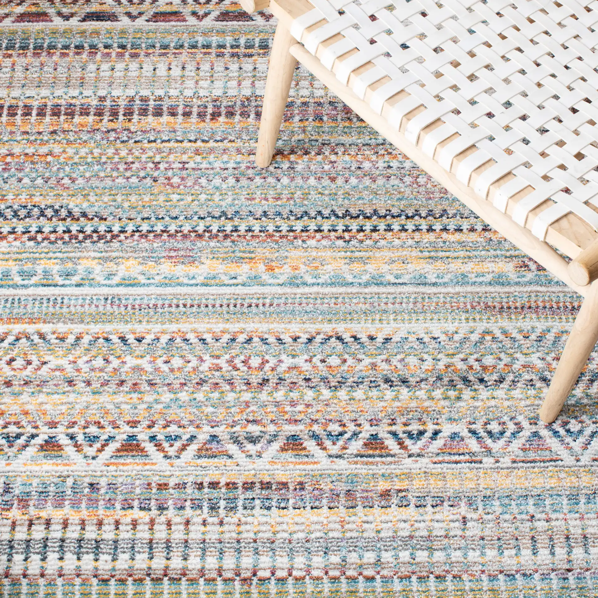 Crystal Banded Geometric Rug in Rust / Gold in a styled room