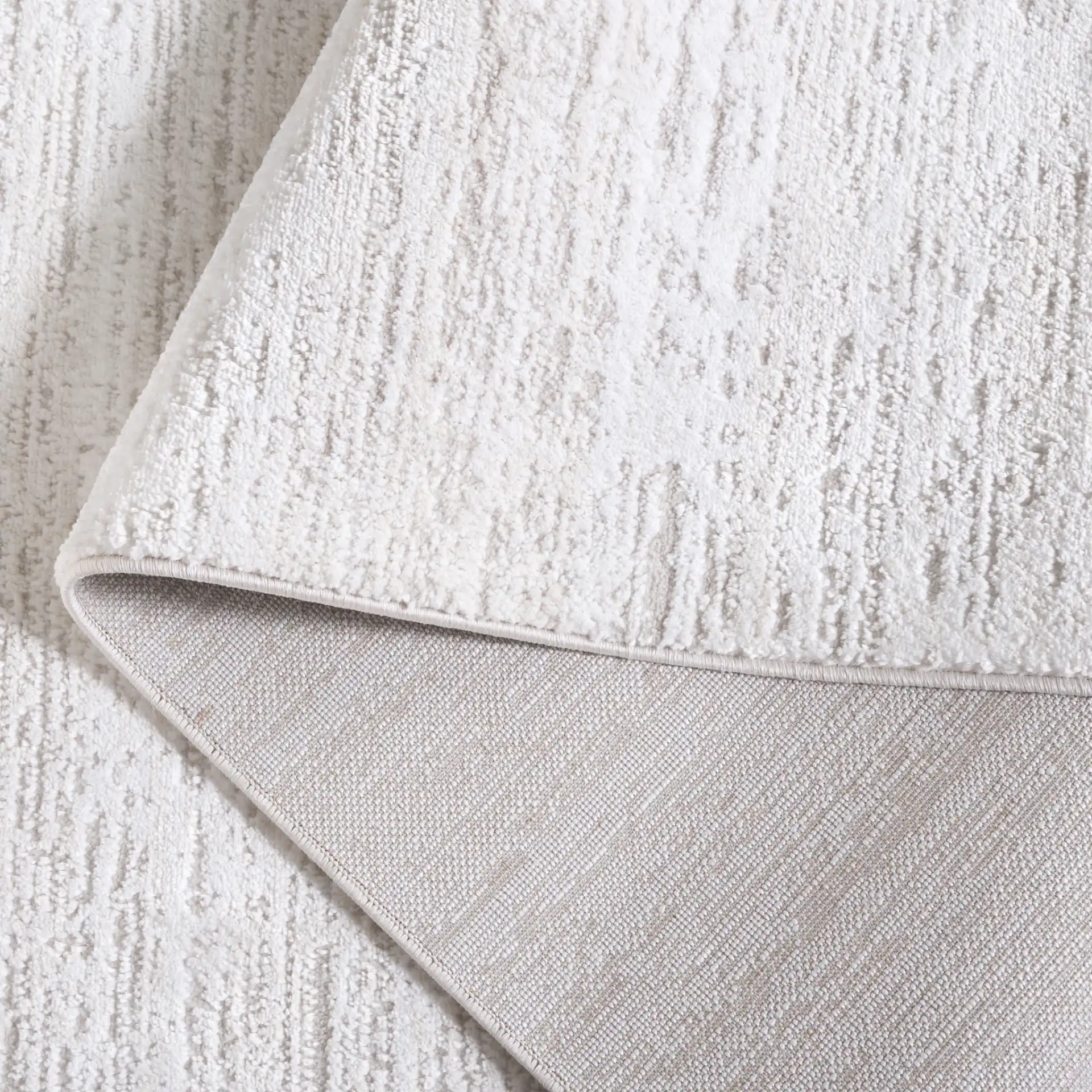 Carter Linear Striation Rug in Ivory / Taupe in a styled room