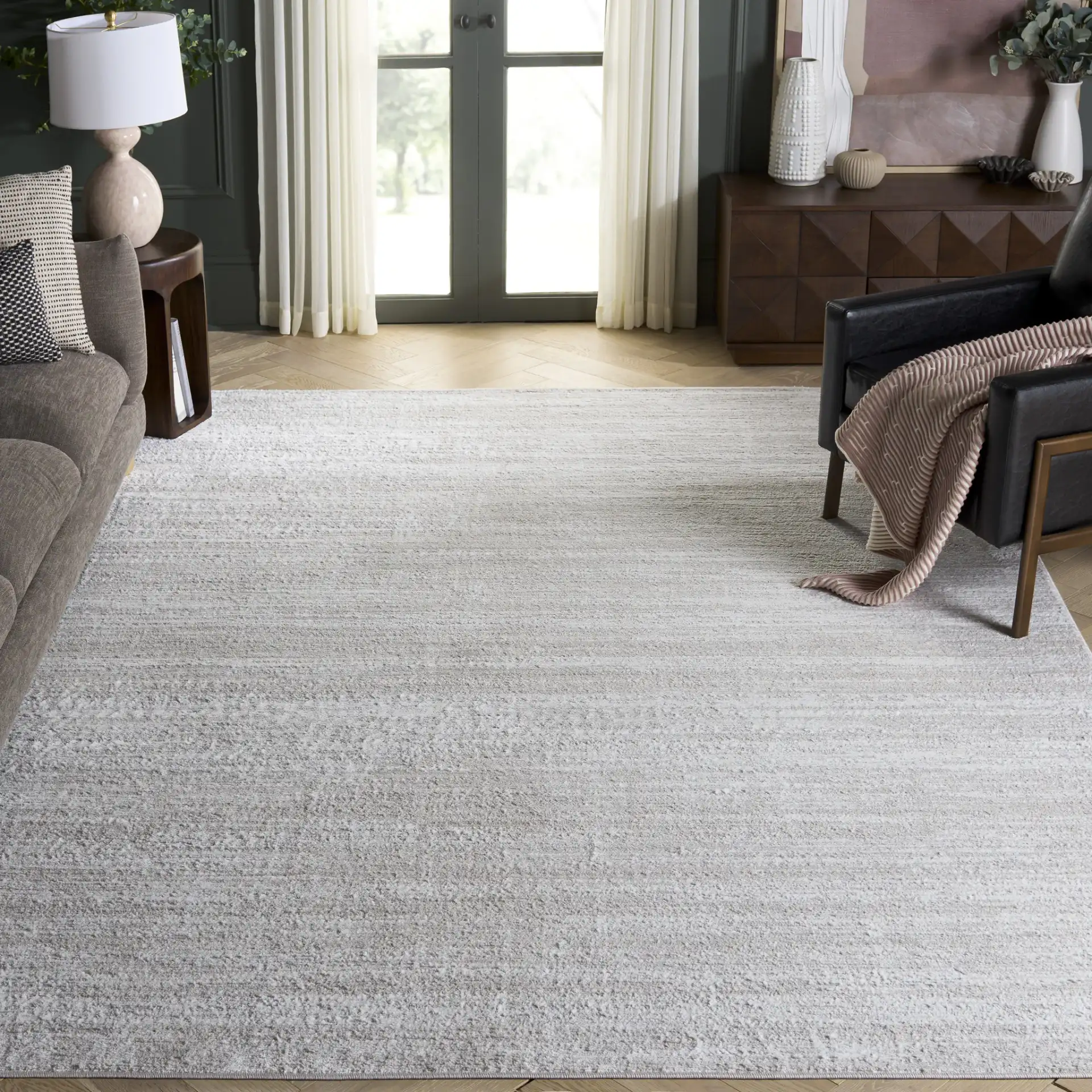 Carter Linear Striation Rug in Ivory / Taupe in a styled room