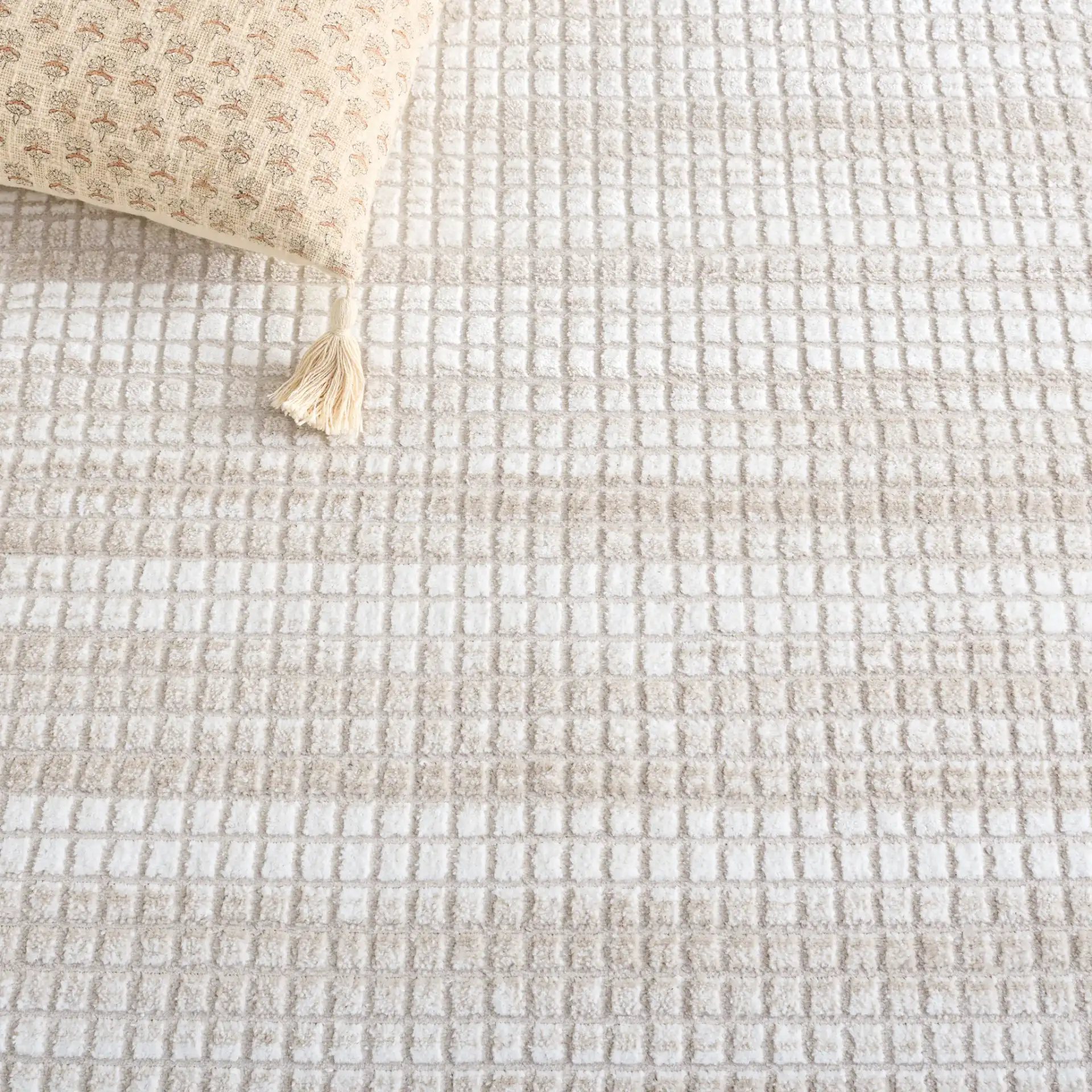 Carter Grid Rug in Ivory / Taupe in a styled room
