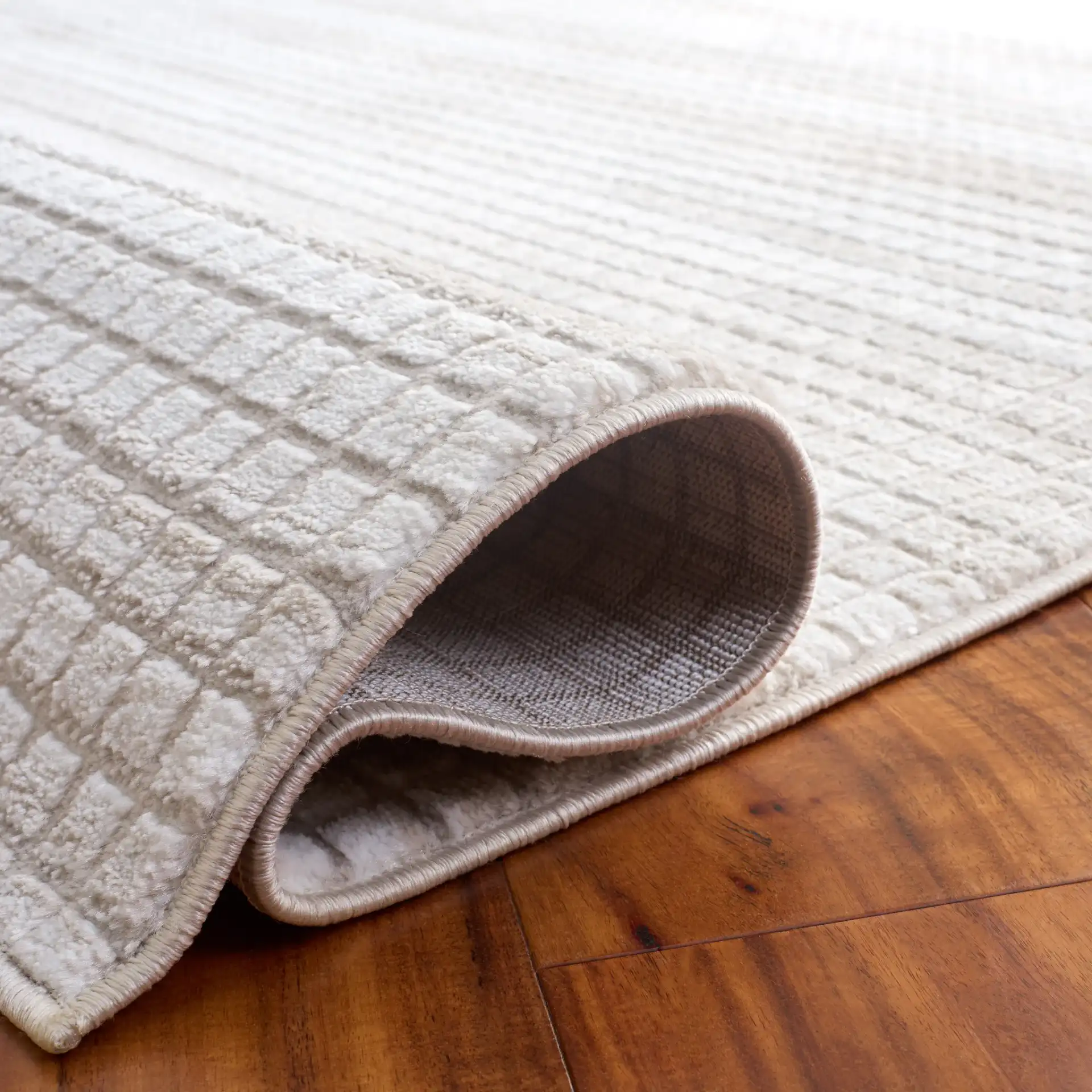 Carter Grid Rug in Ivory / Taupe in a styled room