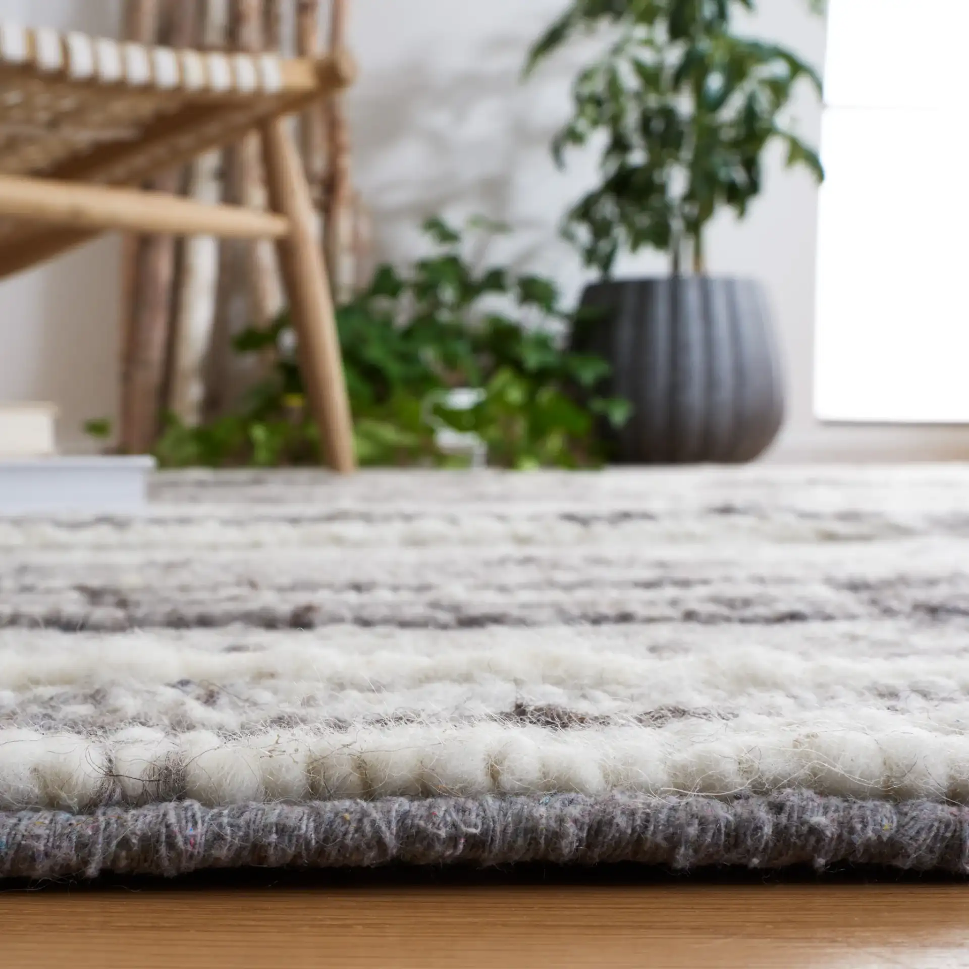 Casablanca Striped Hand-Woven Wool Rug in Gray / Ivory in a styled room