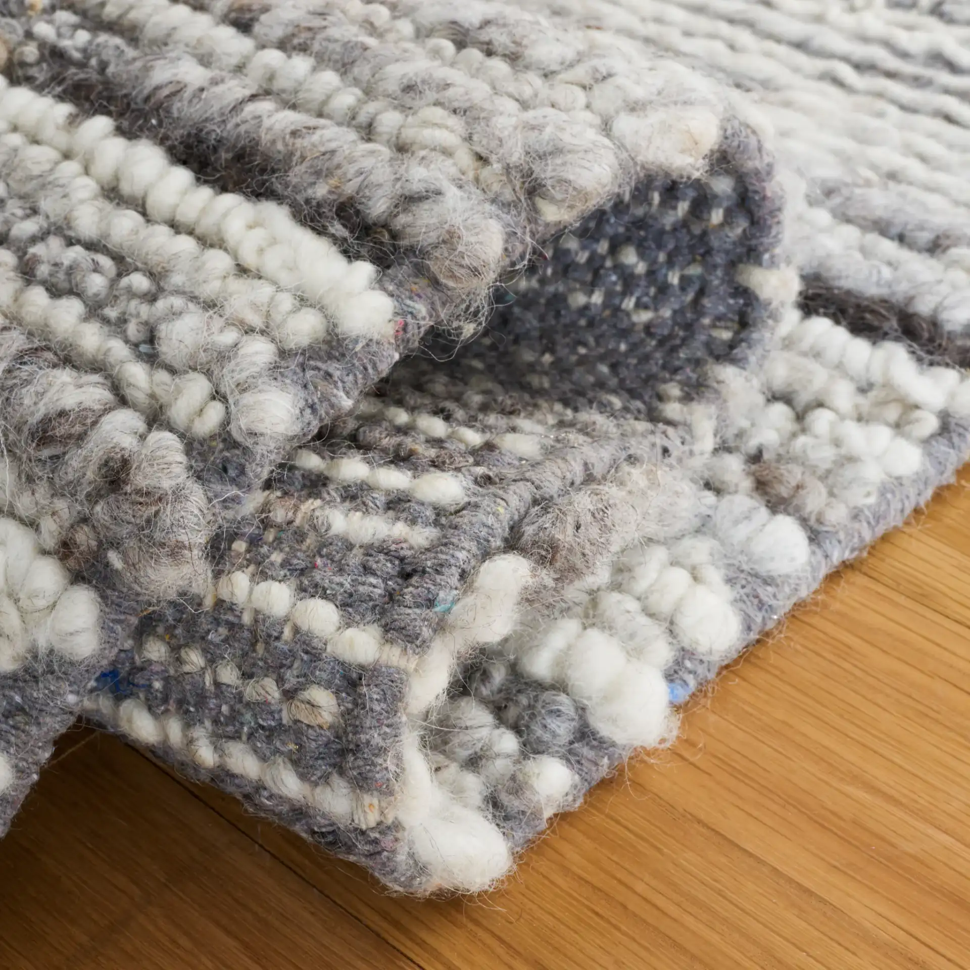 Casablanca Striped Hand-Woven Wool Rug in Gray / Ivory in a styled room