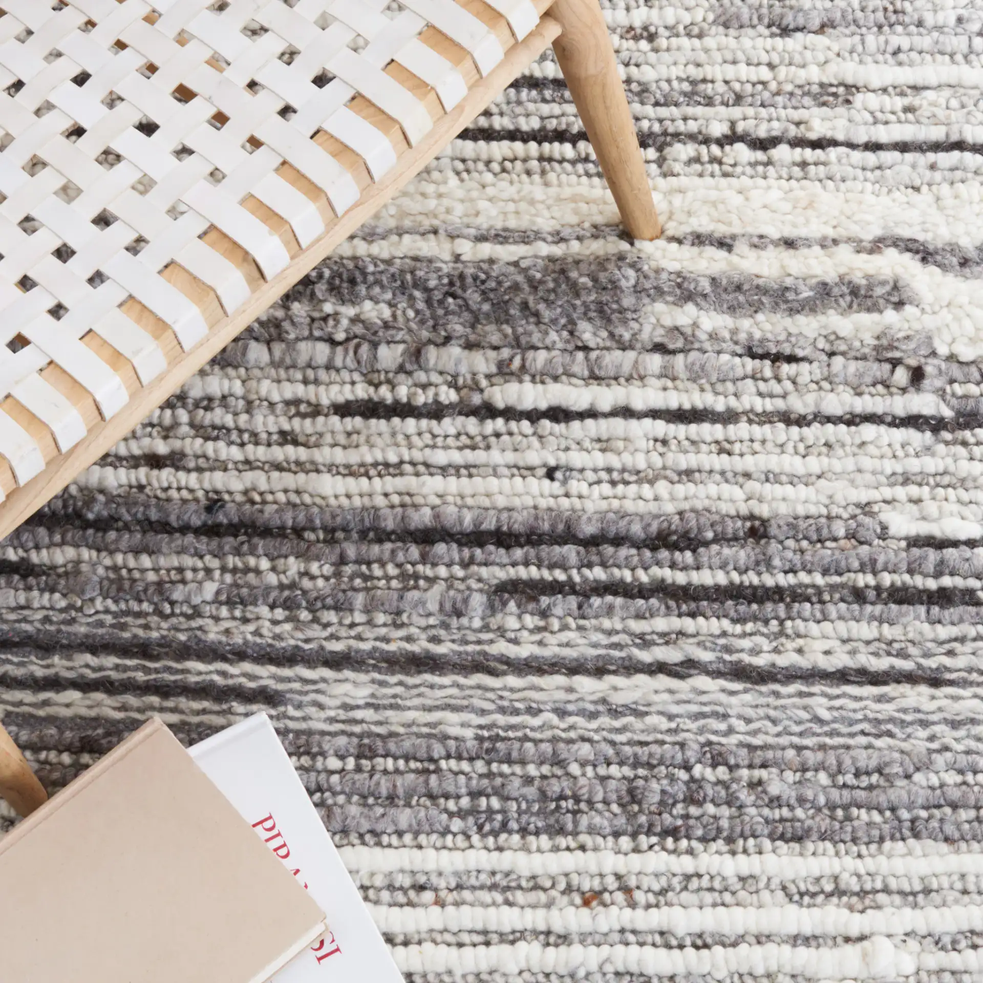 Casablanca Striped Hand-Woven Wool Rug in Gray / Ivory in a styled room