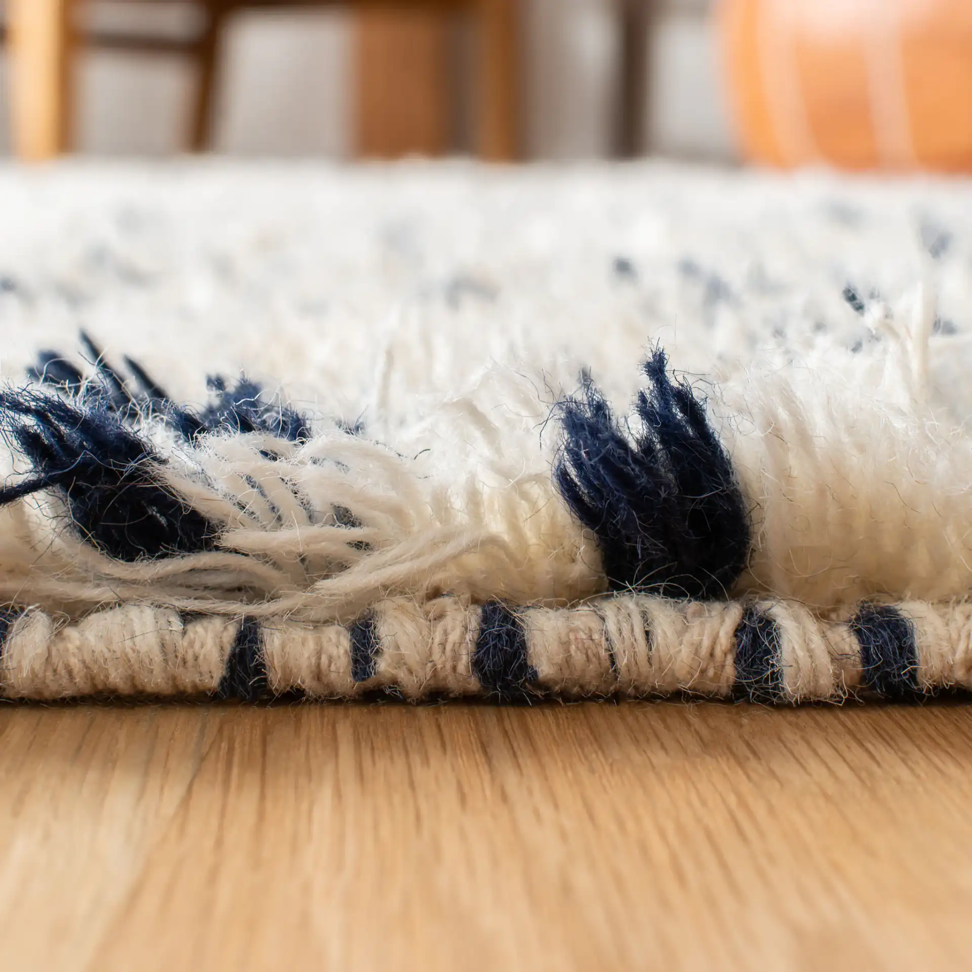 Casablanca Diamond Hand-Woven Shag Wool Rug in Ivory / Navy in a styled room