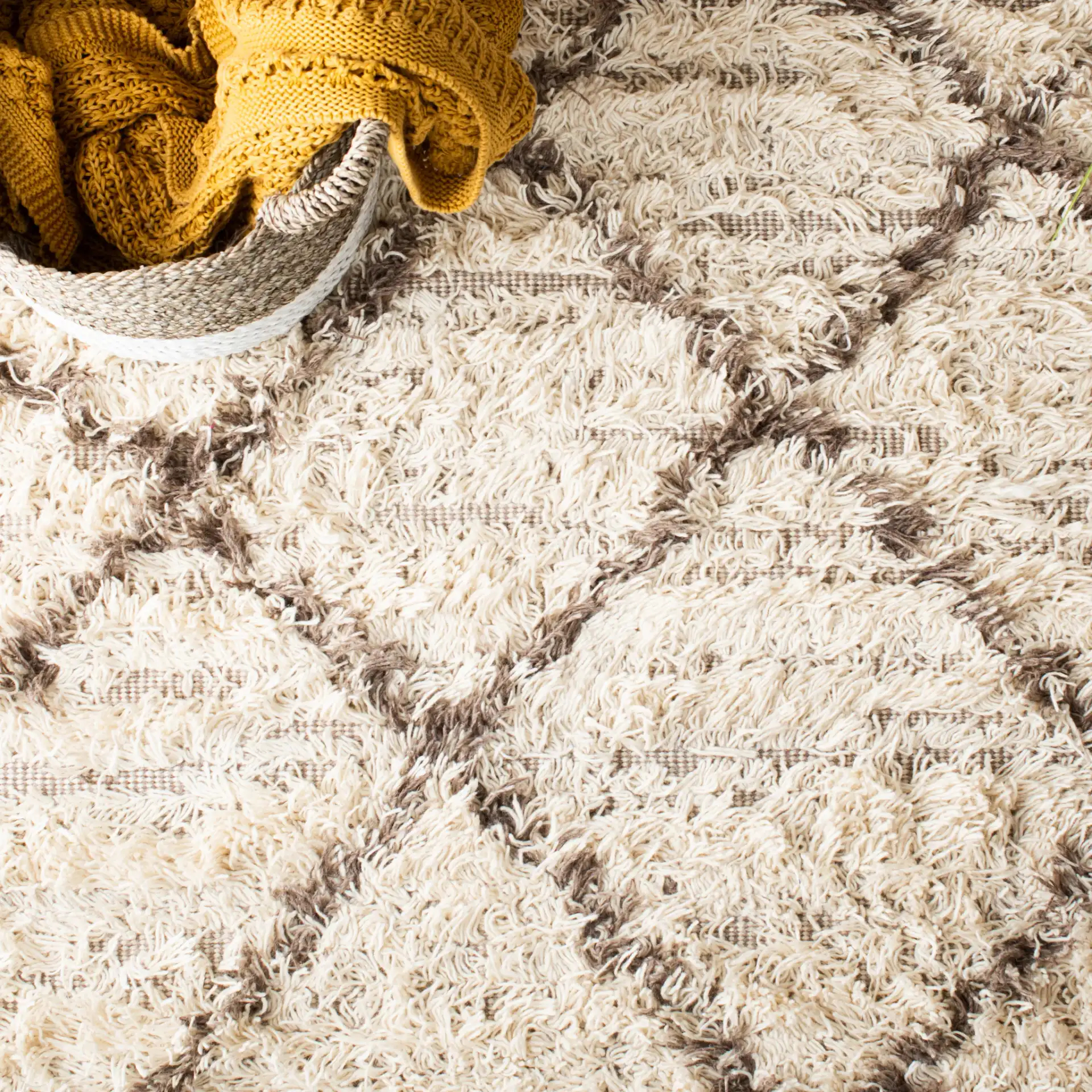 Casablanca Diamond Trellis Hand-Woven Shag Rug in Ivory / Taupe in a styled room