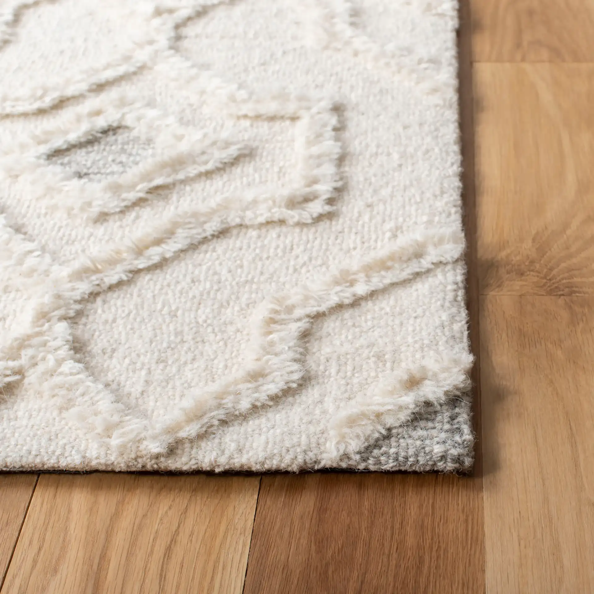 Casablanca Carved Trellis Hand-Tufted Wool Rug in Ivory in a styled room