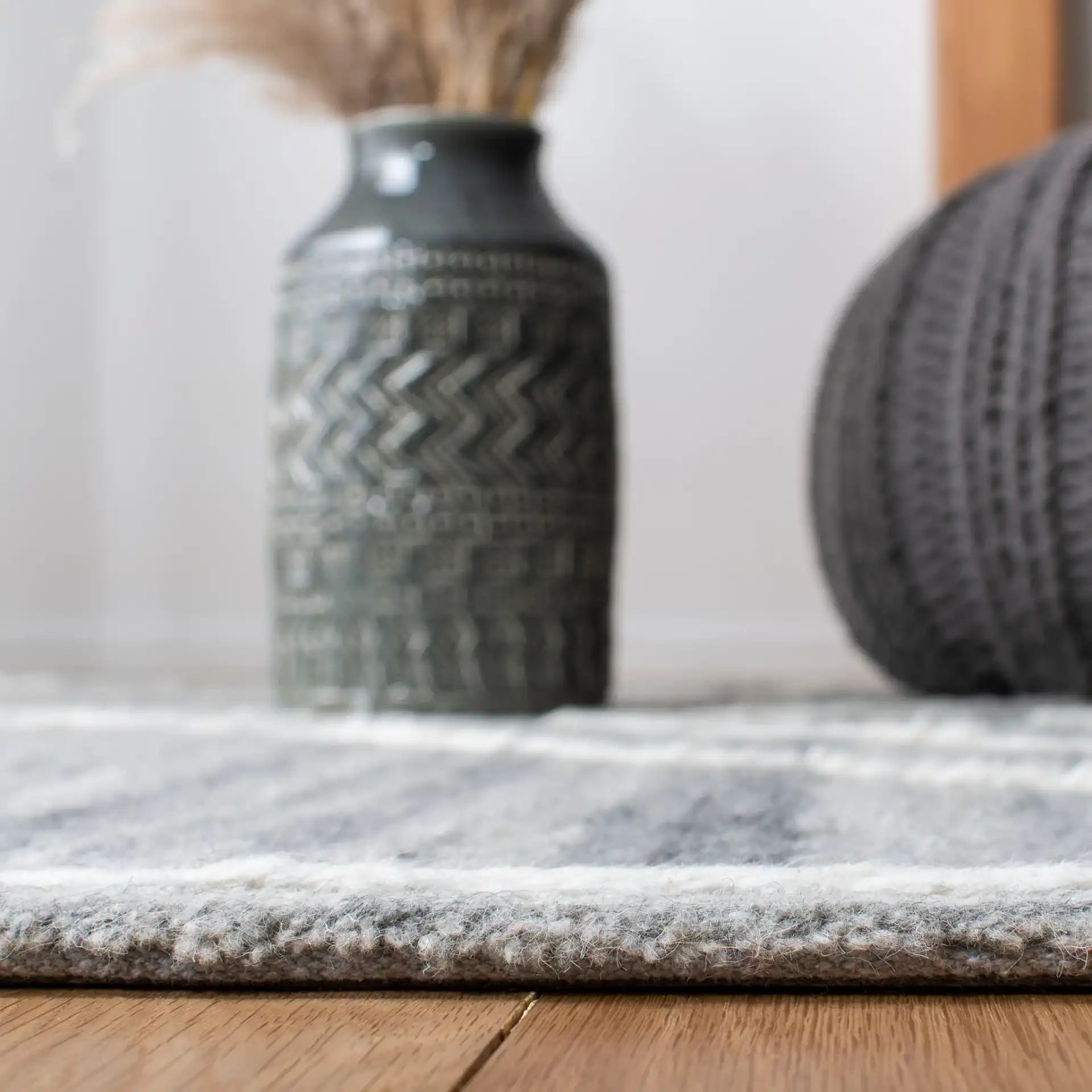 Casablanca Concentric Diamond Hand-Tufted Wool Rug in Gray / Ivory in a styled room