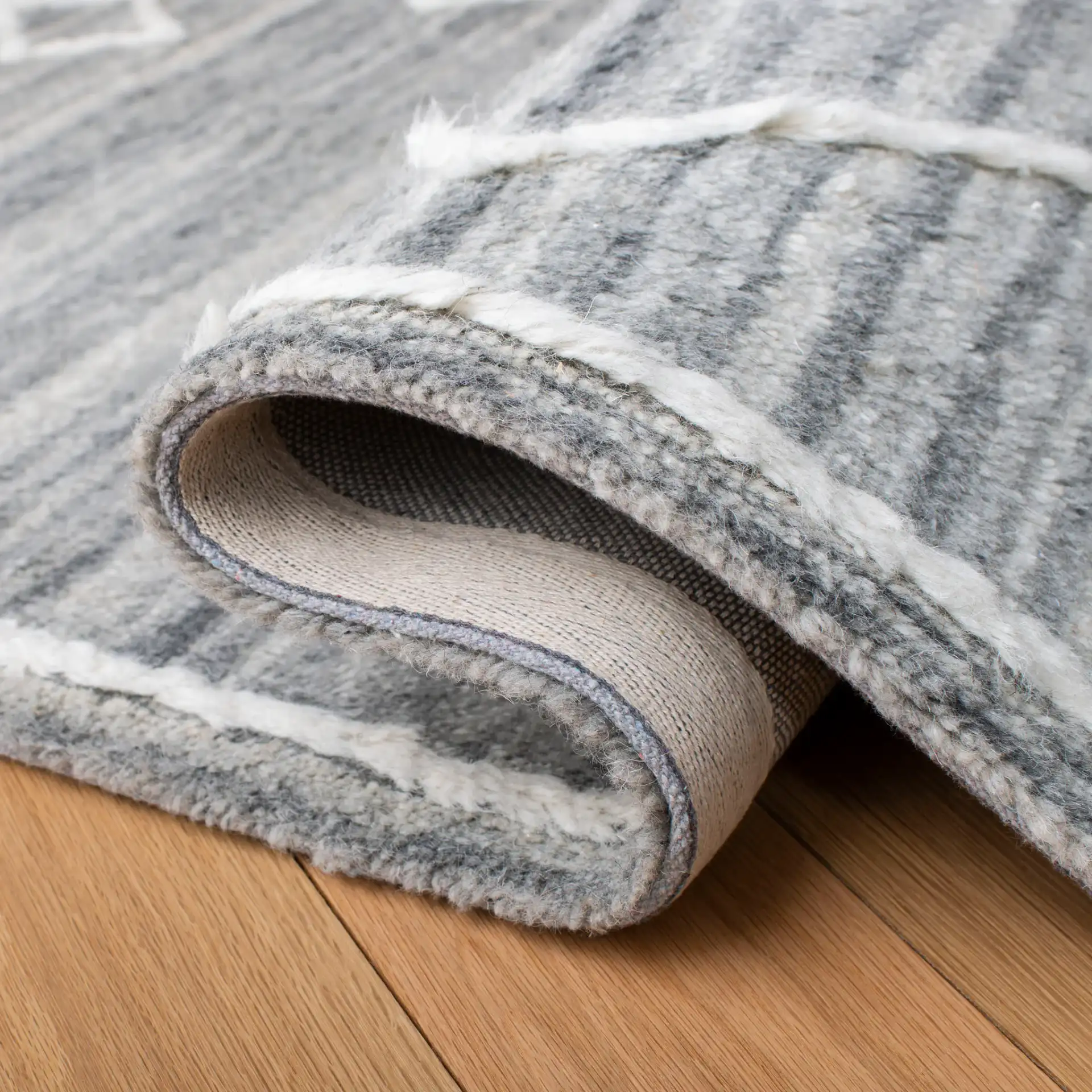 Casablanca Concentric Diamond Hand-Tufted Wool Rug in Gray / Ivory in a styled room