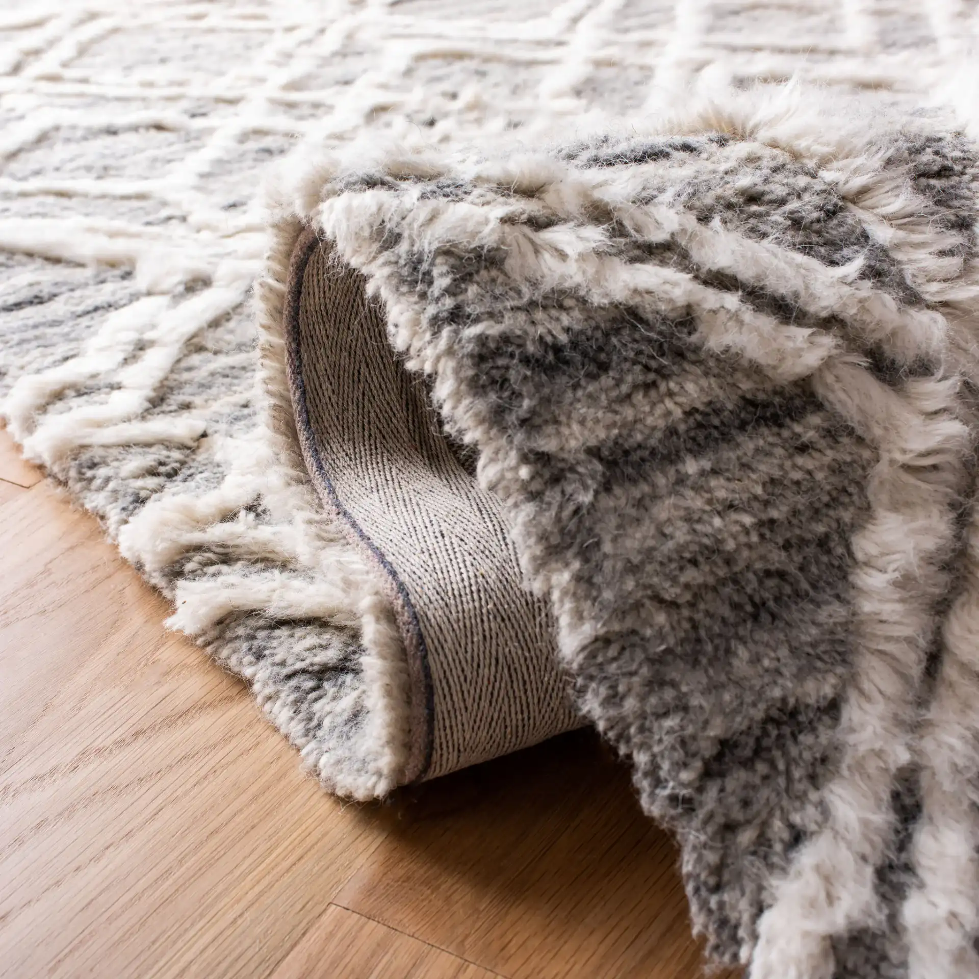 Casablanca Geometric Diamond Trellis Hand-Tufted Wool Rug in Gray / Ivory in a styled room