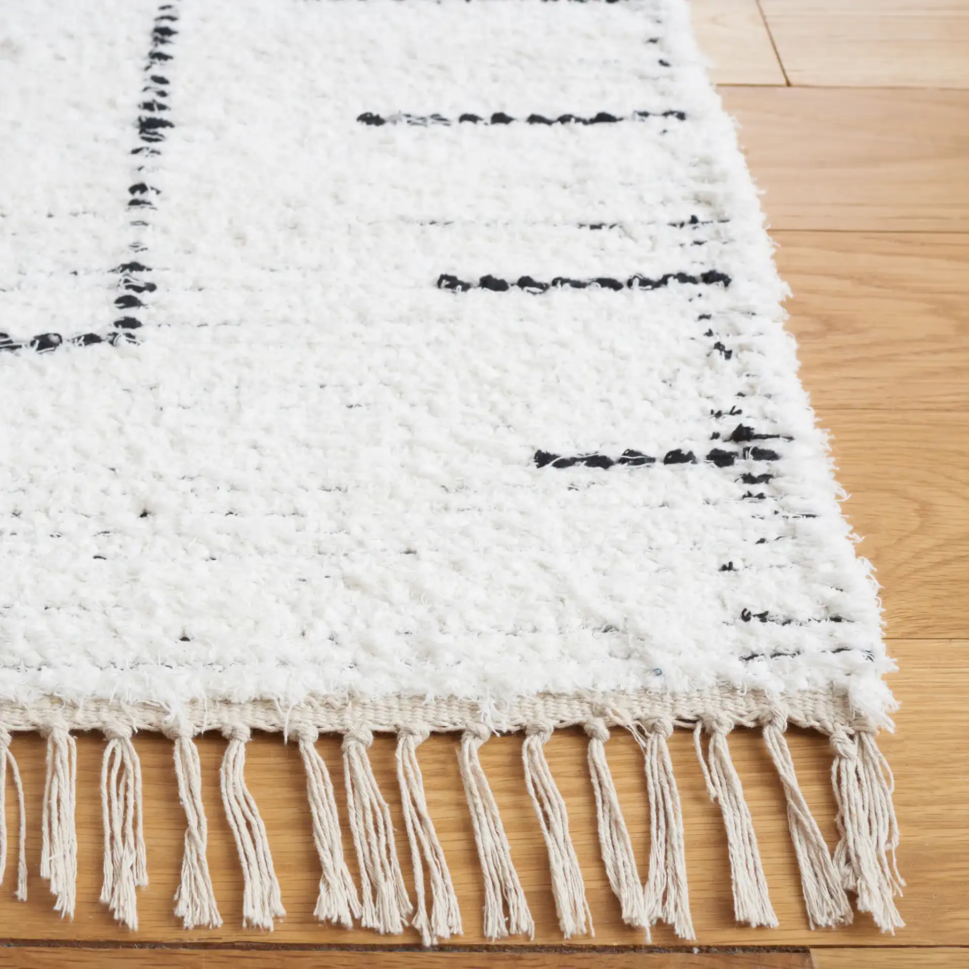 Casablanca Stacked Rectangle Hand-Woven Cotton Rug in Ivory / Black in a styled room