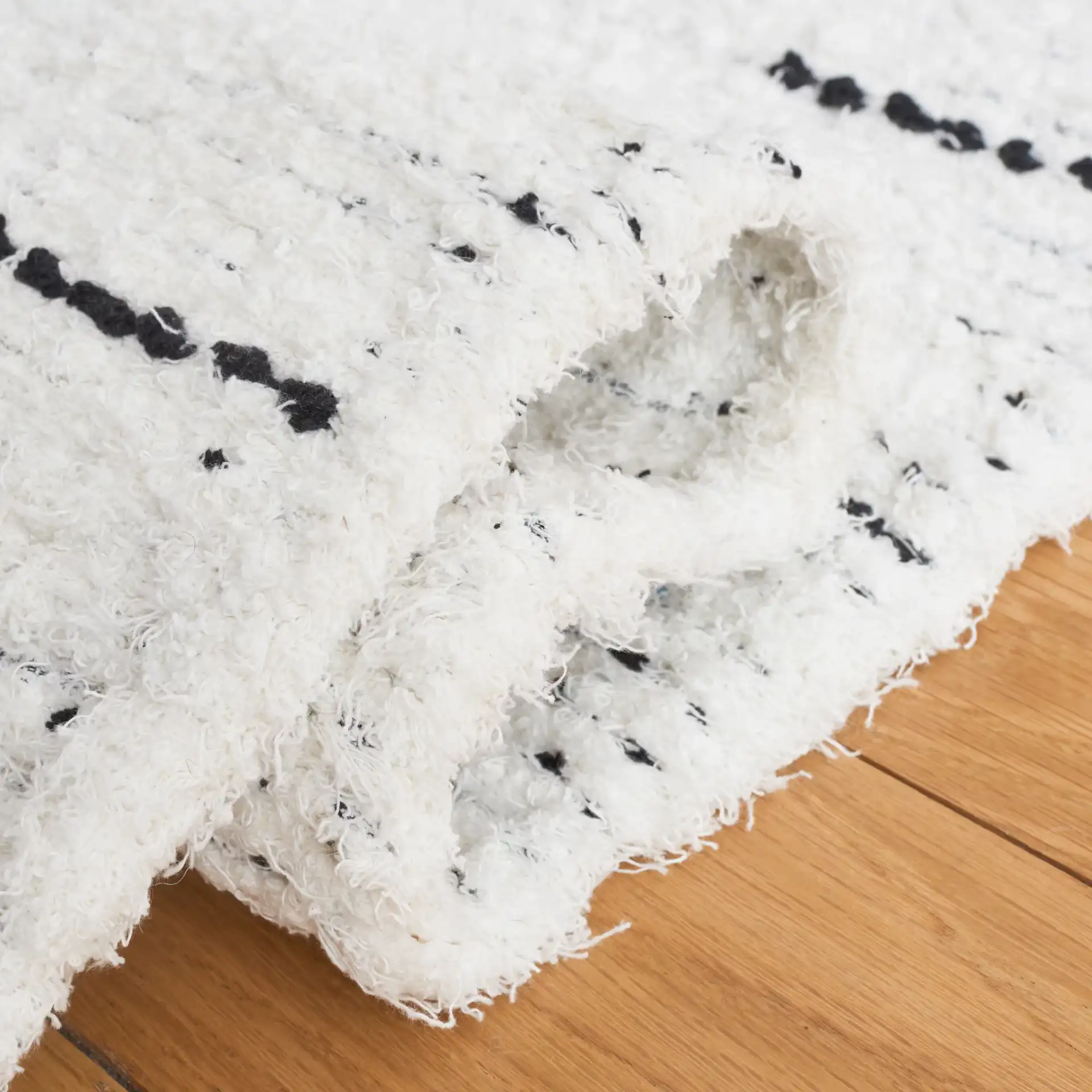 Casablanca Stacked Rectangle Hand-Woven Cotton Rug in Ivory / Black in a styled room