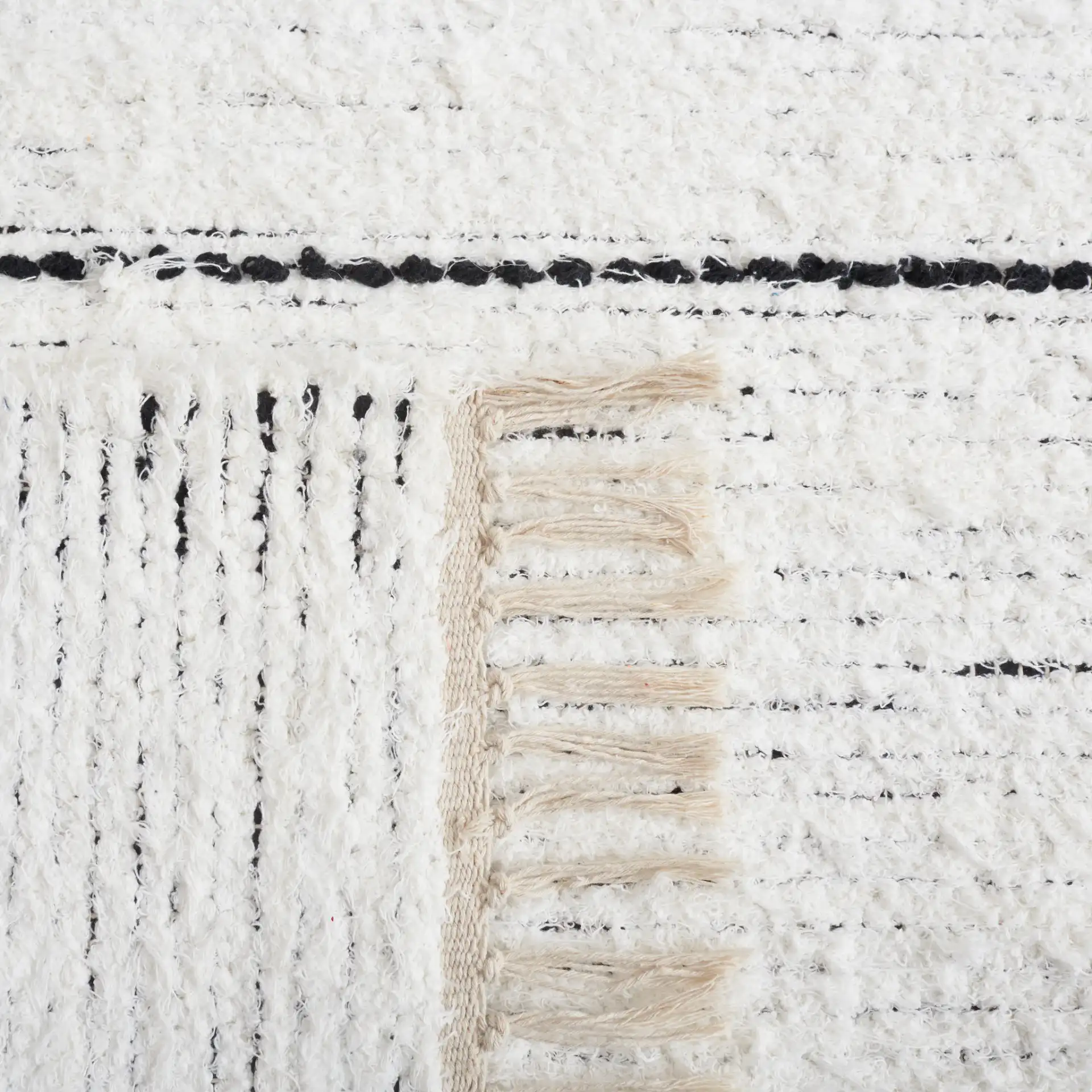 Casablanca Stacked Rectangle Hand-Woven Cotton Rug in Ivory / Black in a styled room