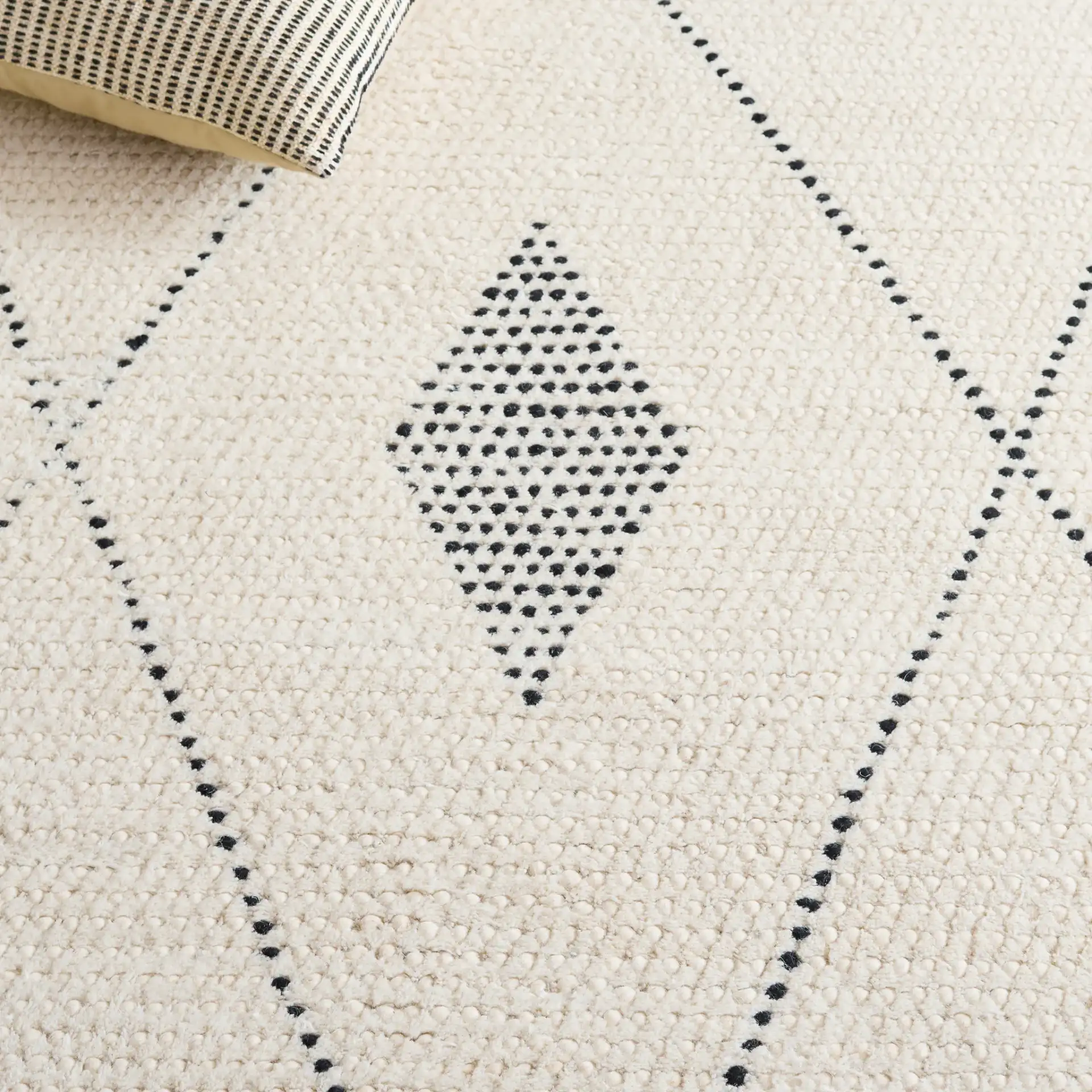 Casablanca Moroccan Tribal Hand-Woven Wool Rug in Ivory / Black in a styled room