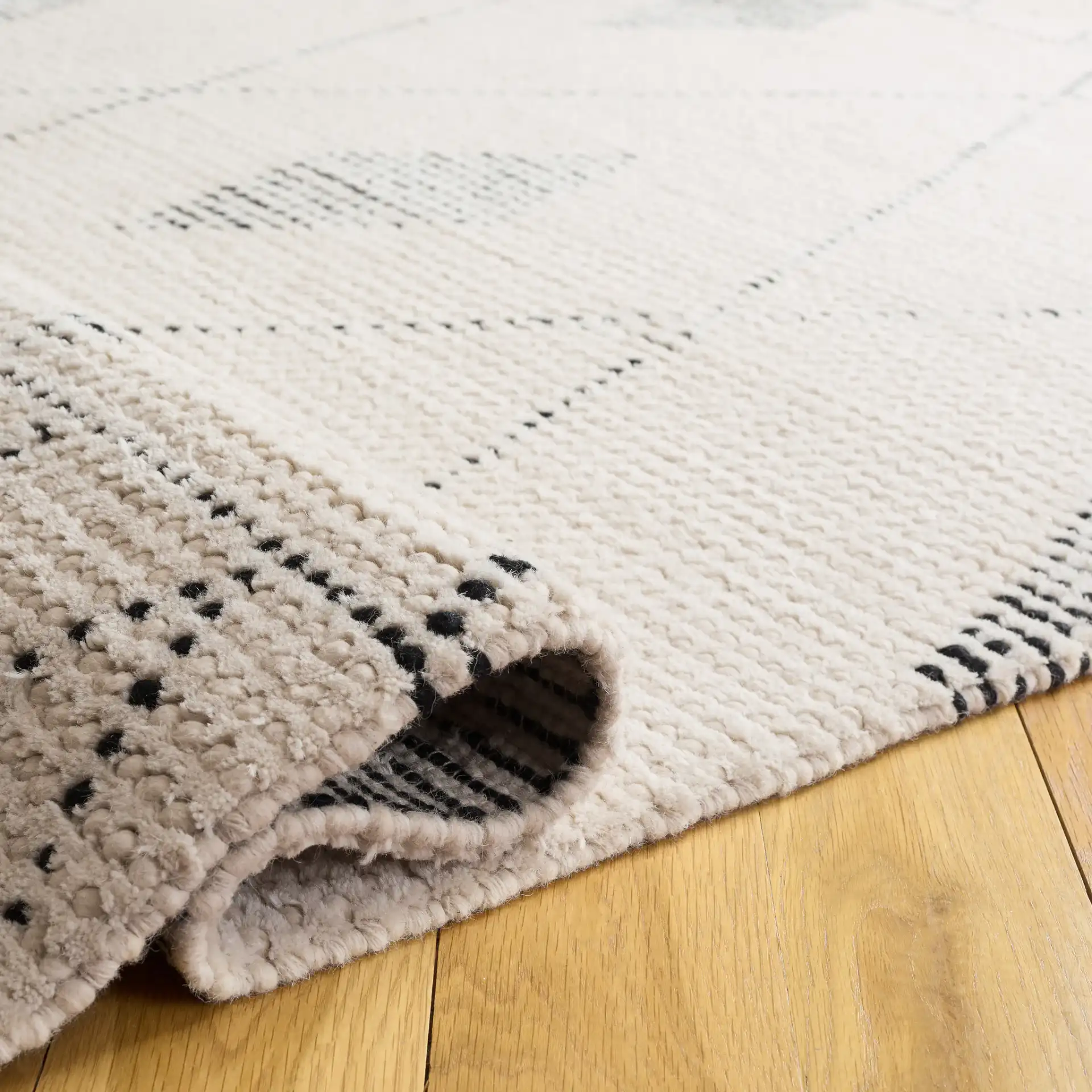 Casablanca Moroccan Tribal Hand-Woven Wool Rug in Ivory / Black in a styled room