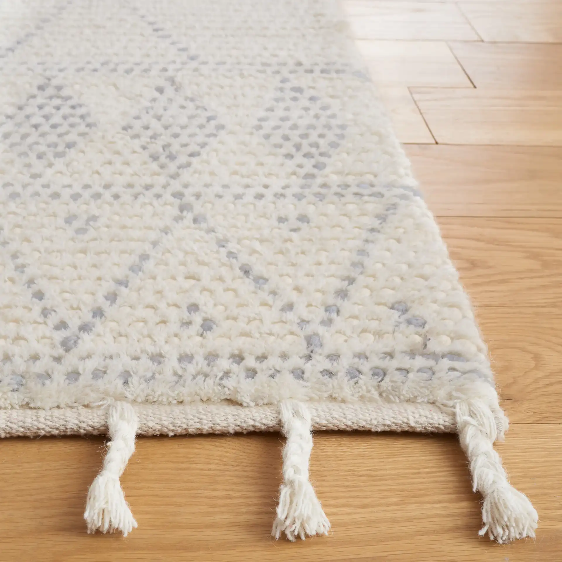 Casablanca Tribal Diamond Band Hand-Woven Wool Rug in Ivory / Gray in a styled room