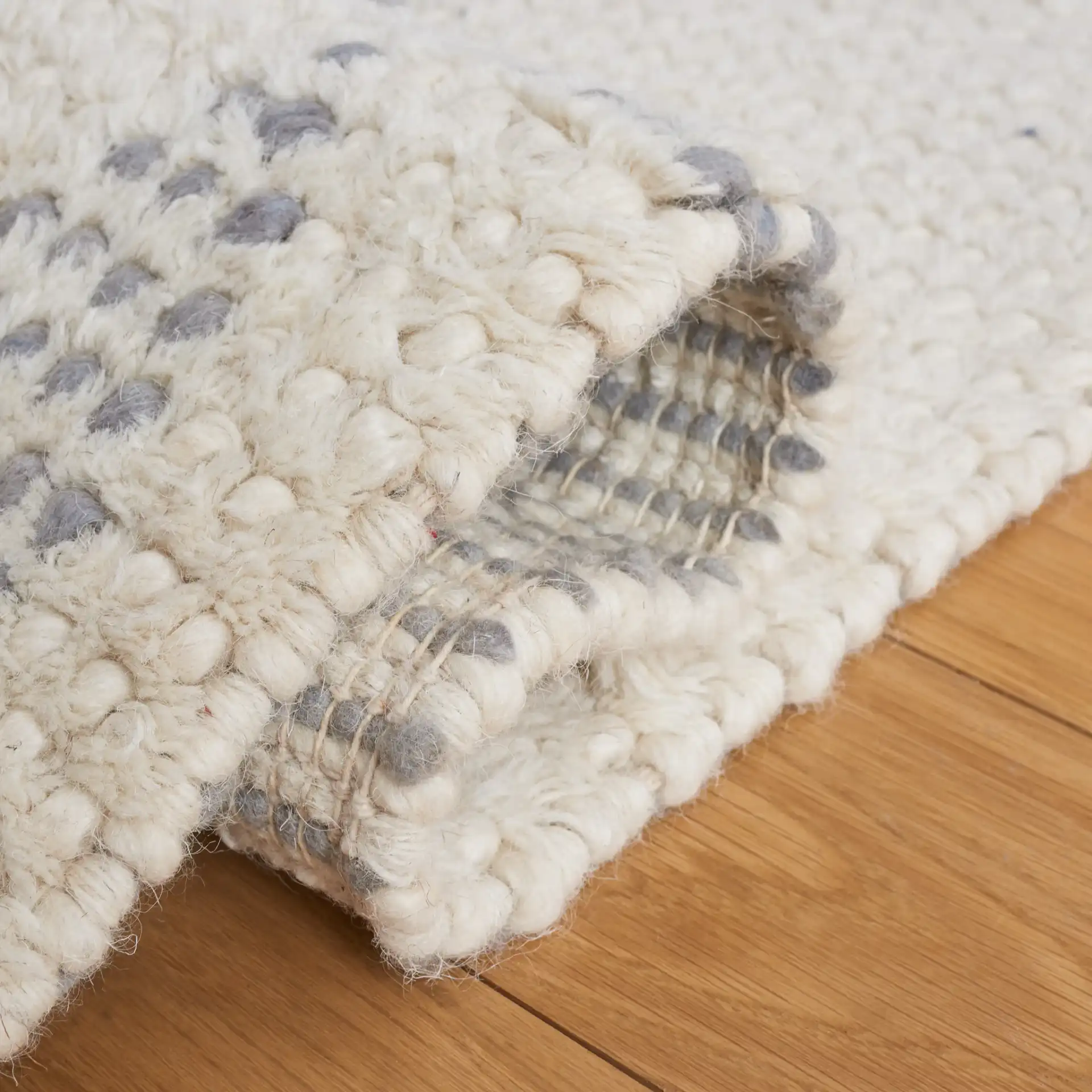Casablanca Tribal Diamond Band Hand-Woven Wool Rug in Ivory / Gray in a styled room
