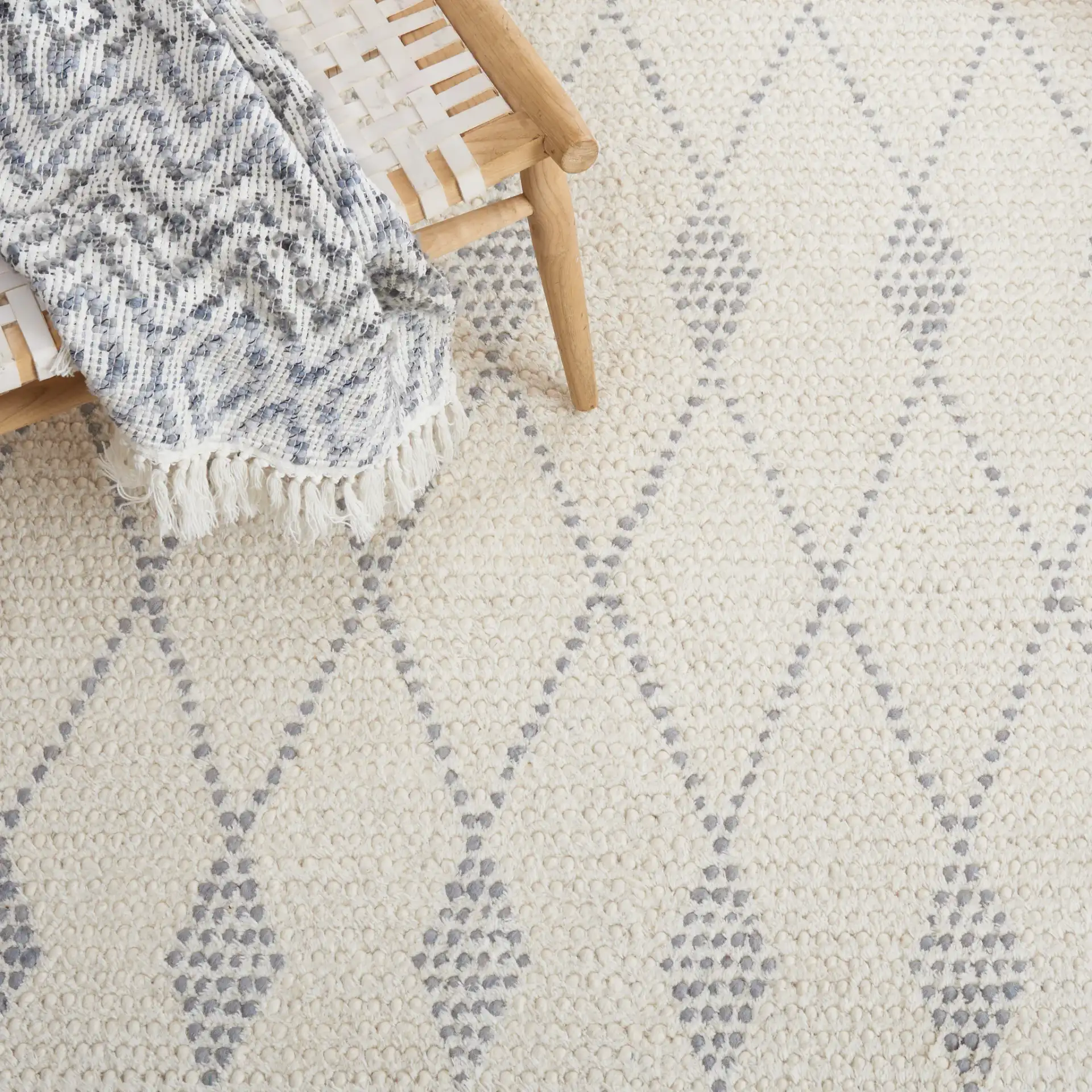 Casablanca Tribal Diamond Band Hand-Woven Wool Rug in Ivory / Gray in a styled room