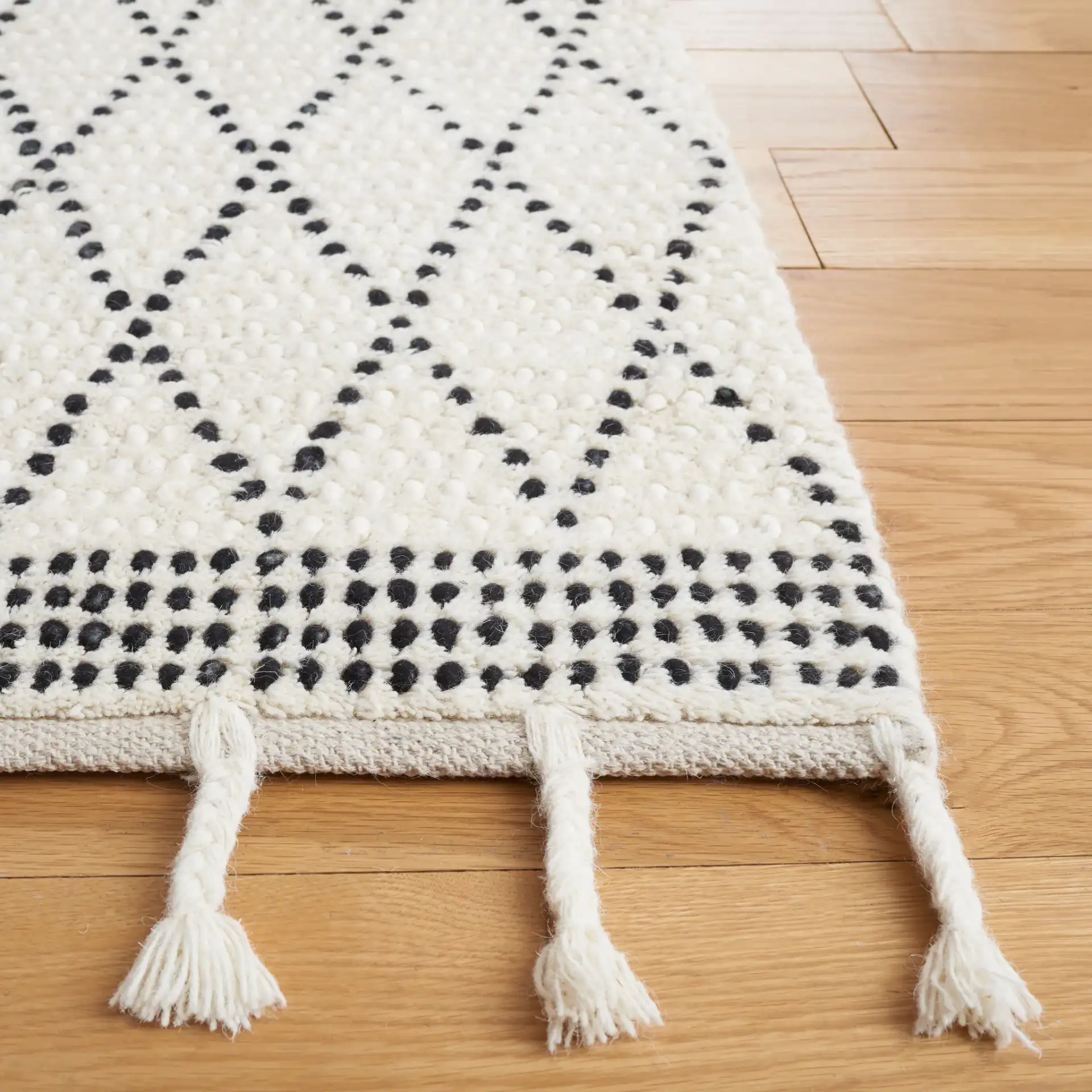 Casablanca Dotted Diamond Hand-Woven Wool Rug in Ivory / Black in a styled room