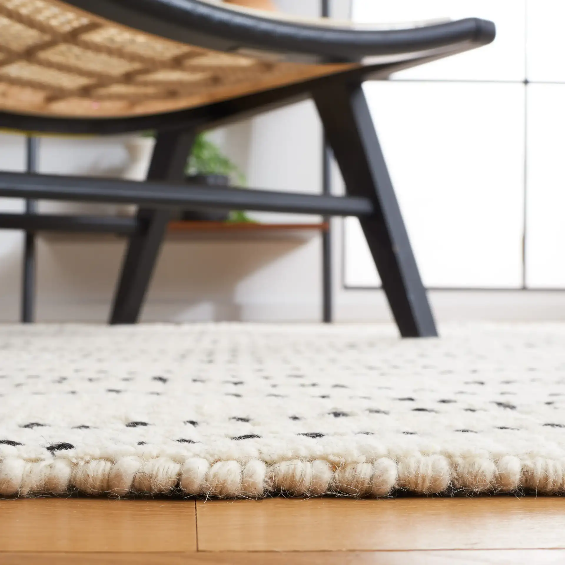 Casablanca Dotted Diamond Hand-Woven Wool Rug in Ivory / Black in a styled room
