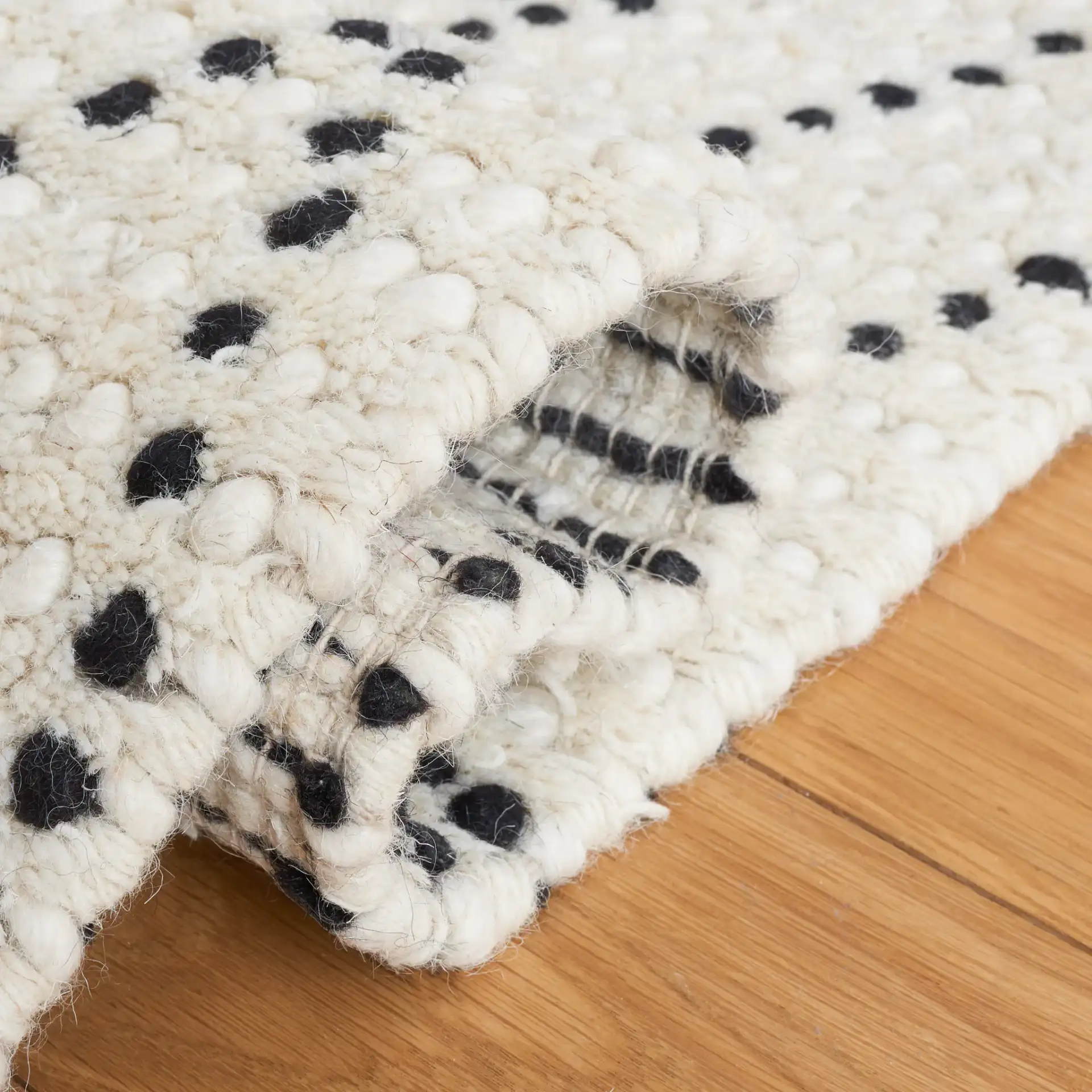 Casablanca Dotted Diamond Hand-Woven Wool Rug in Ivory / Black in a styled room