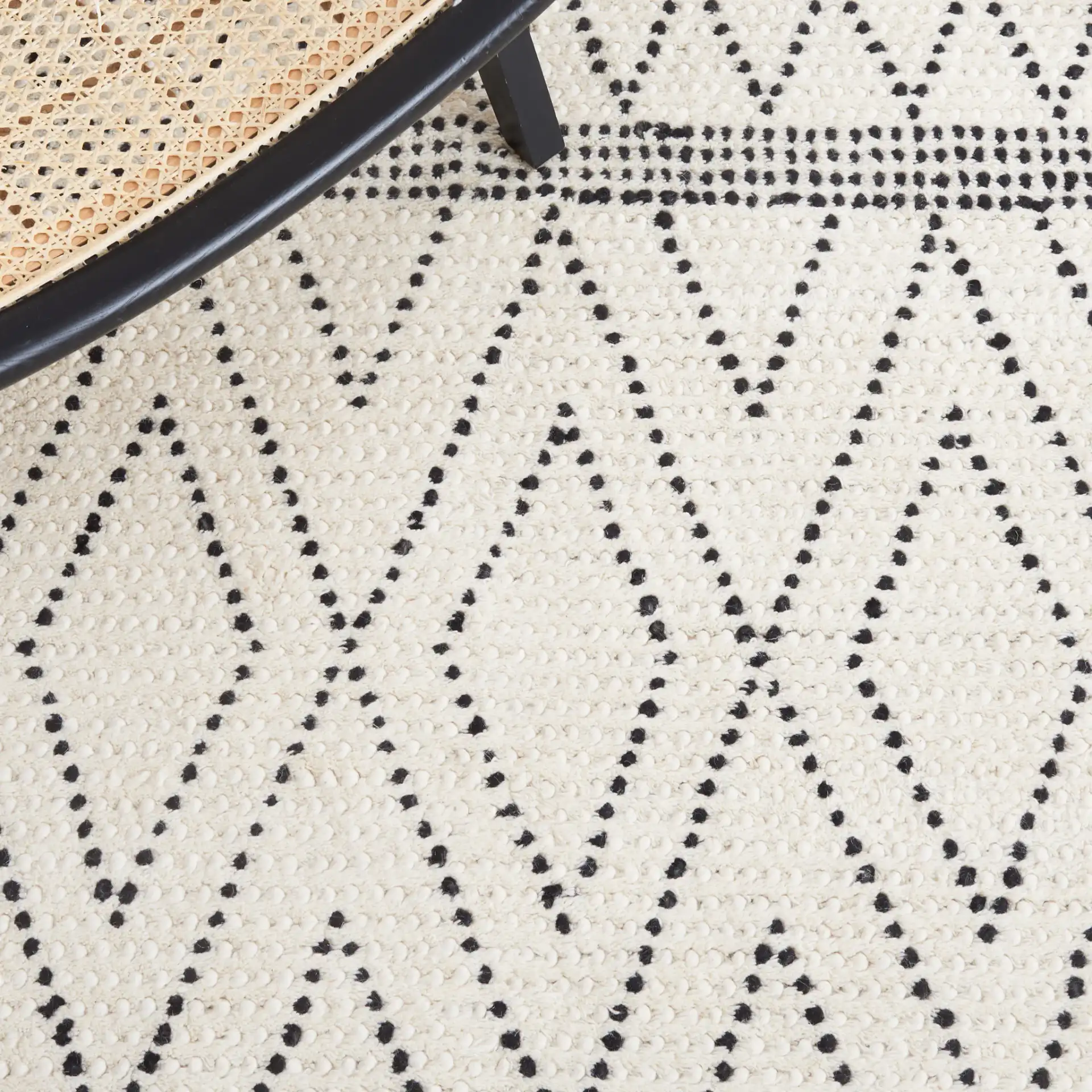 Casablanca Dotted Diamond Hand-Woven Wool Rug in Ivory / Black in a styled room
