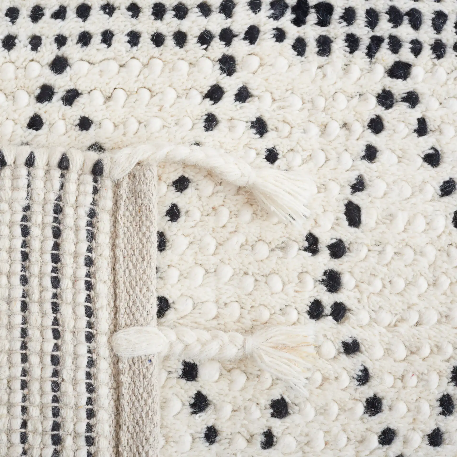 Casablanca Dotted Diamond Hand-Woven Wool Rug in Ivory / Black in a styled room
