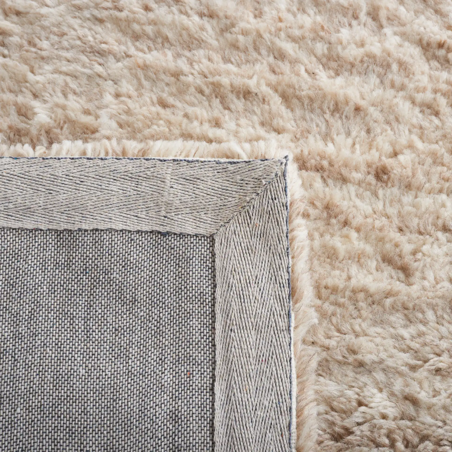 Casablanca Textured Solid Hand-Tufted Wool Rug in Beige in a styled room