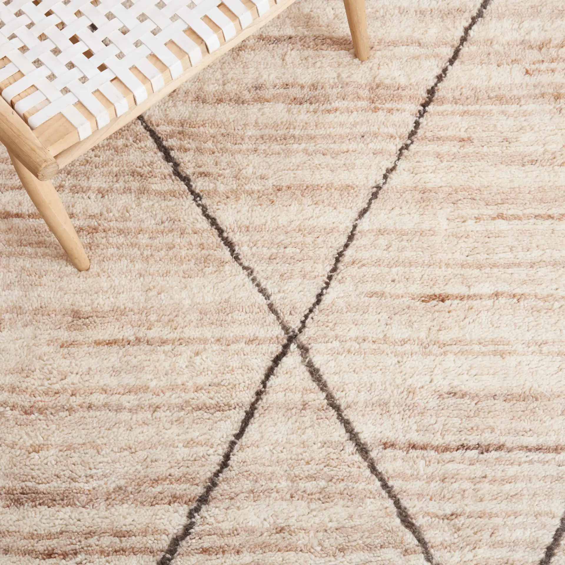 Casablanca Diamond Trellis Hand-Woven Wool Rug in Beige in a styled room