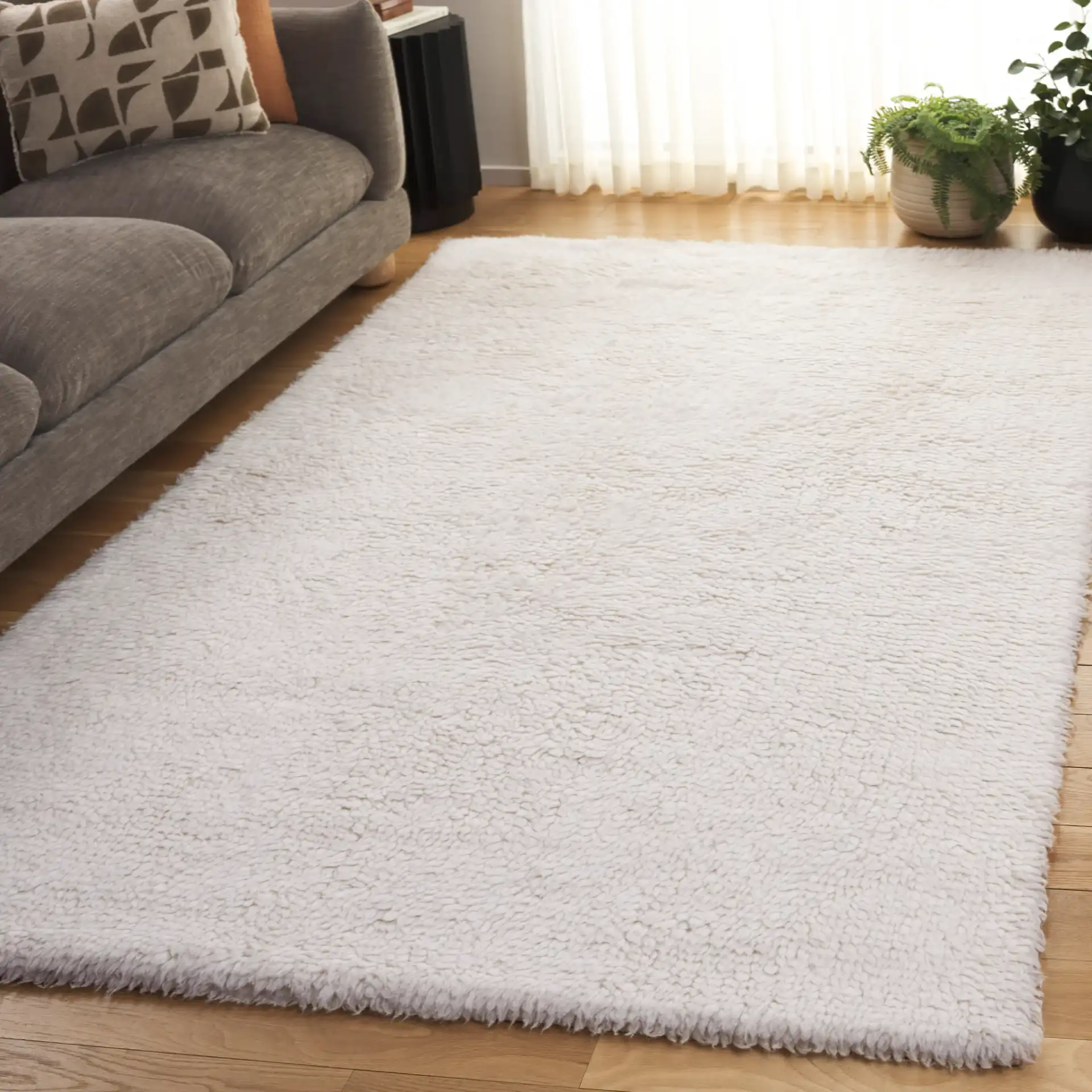 Casablanca Solid Hand-Loomed Wool Shag Rug in Ivory in a styled room