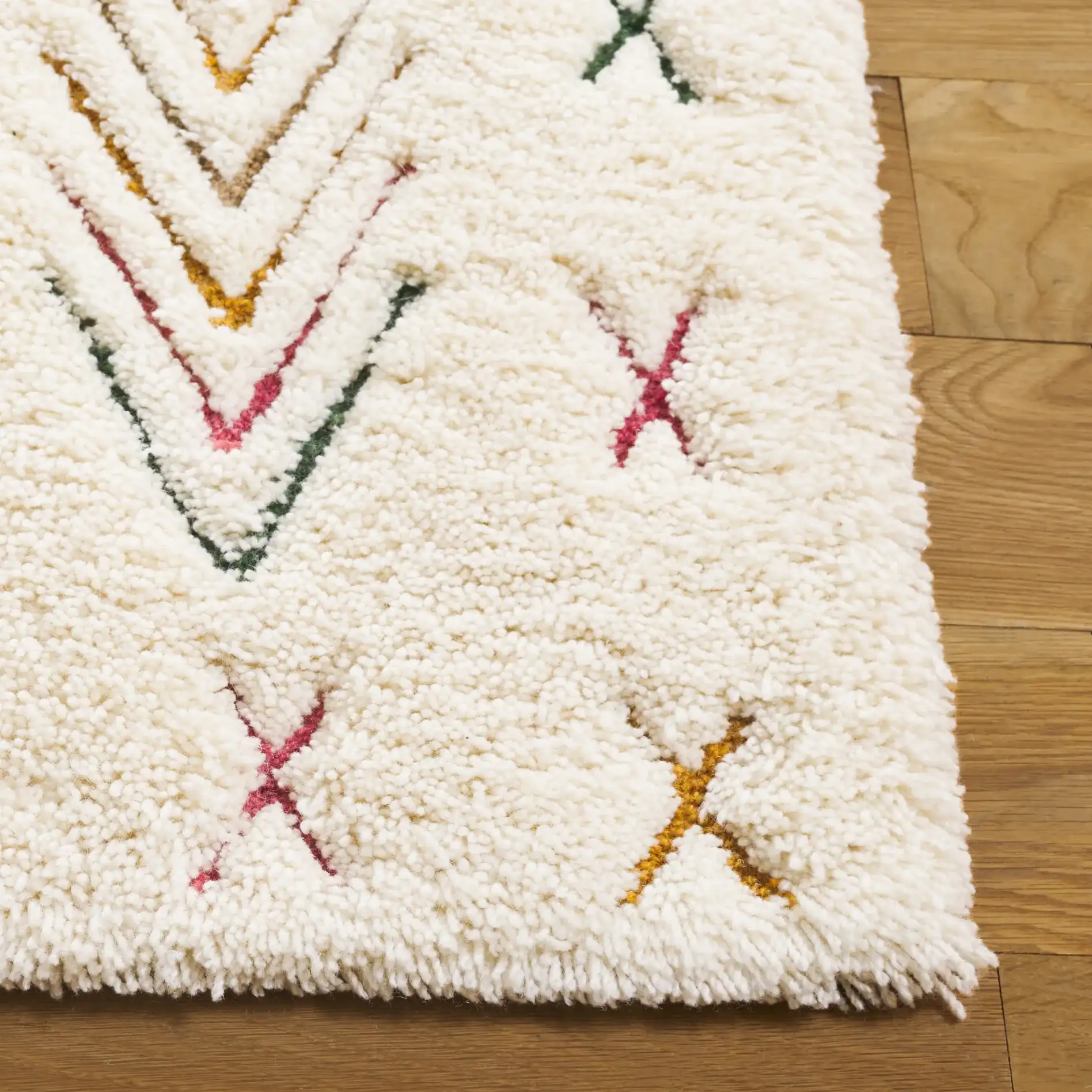 Casablanca Tribal Motif Hand-Tufted Shag Wool Rug in Ivory / Pink in a styled room