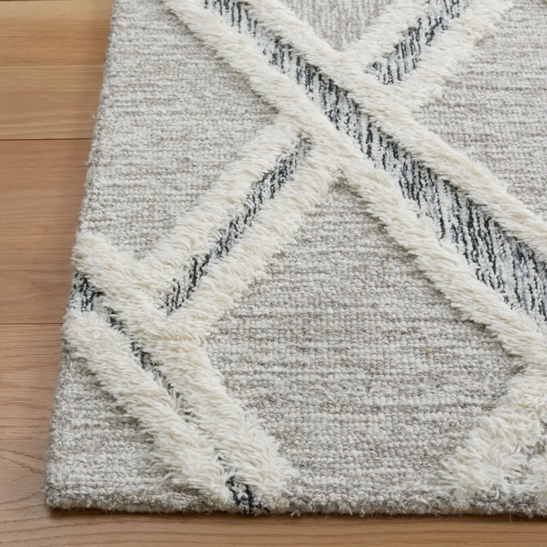 Casablanca Tribal Diamond Hand-Tufted Shag Wool Rug in Gray / Ivory in a styled room