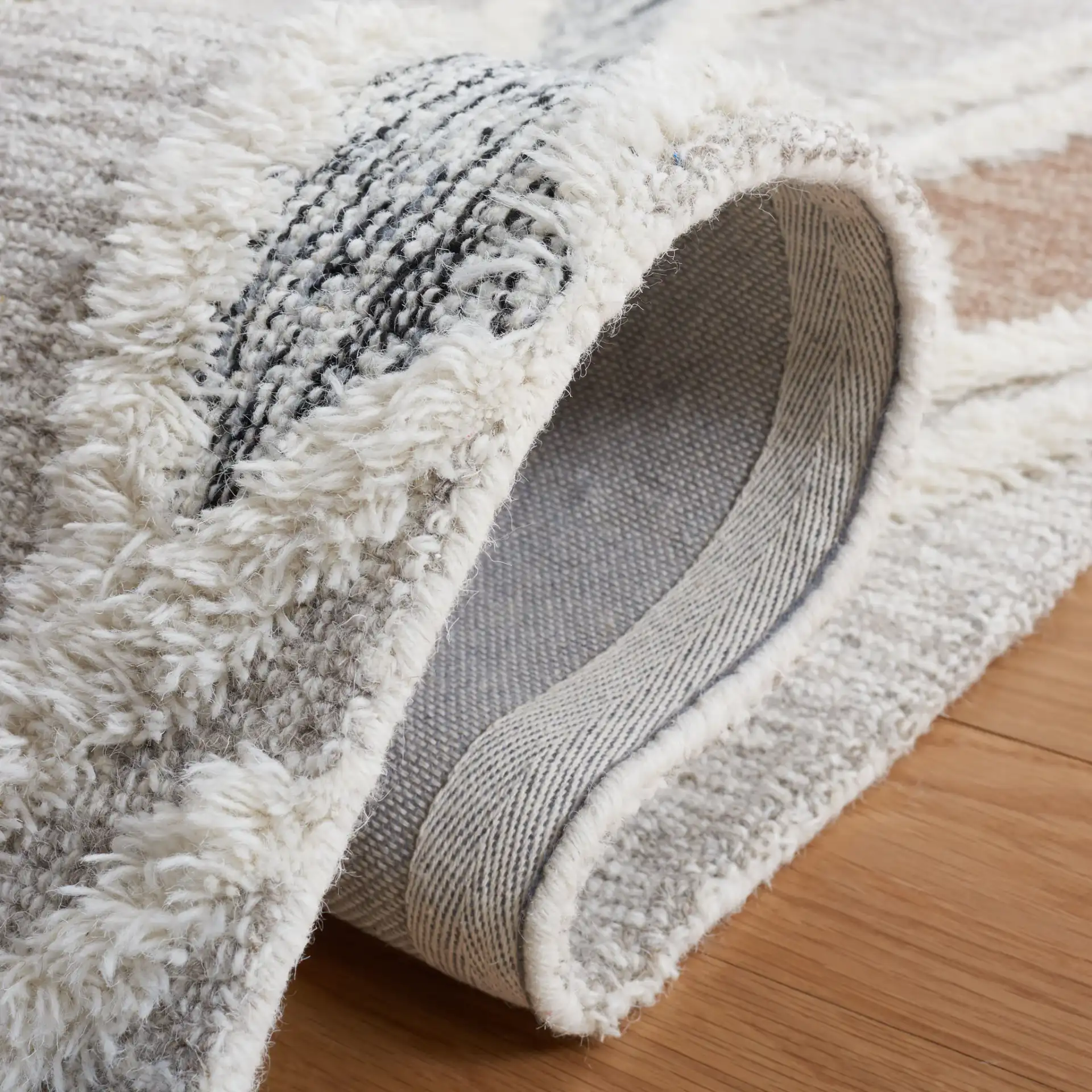 Casablanca Tribal Diamond Hand-Tufted Shag Wool Rug in Gray / Ivory in a styled room