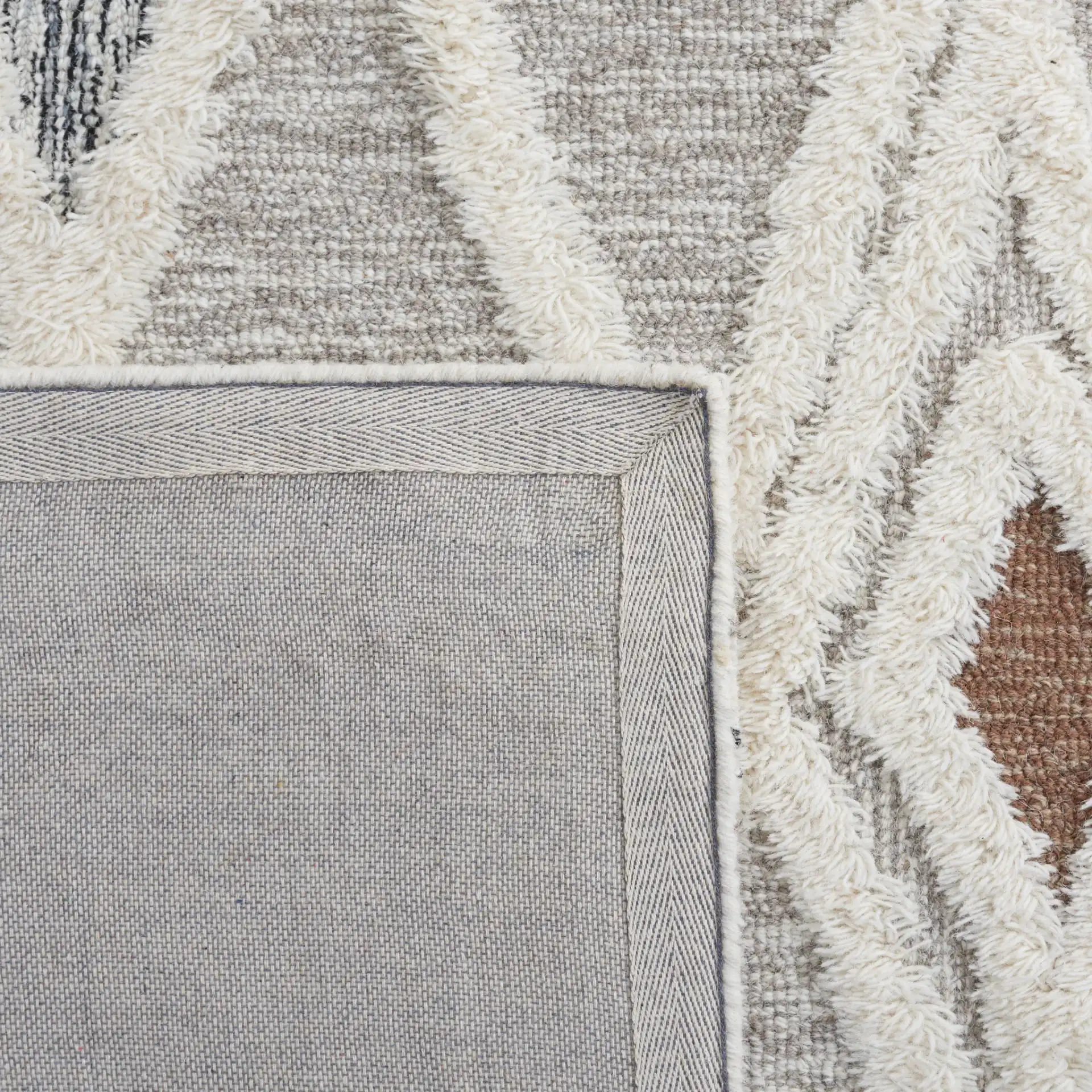 Casablanca Tribal Diamond Hand-Tufted Shag Wool Rug in Gray / Ivory in a styled room