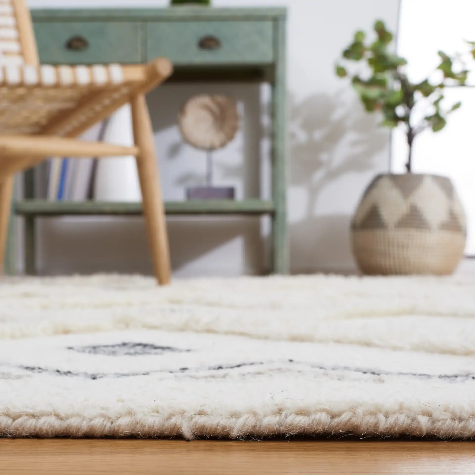 Casablanca Tribal Motif Trellis Hand-Tufted Wool Rug in Ivory / Black in a styled room