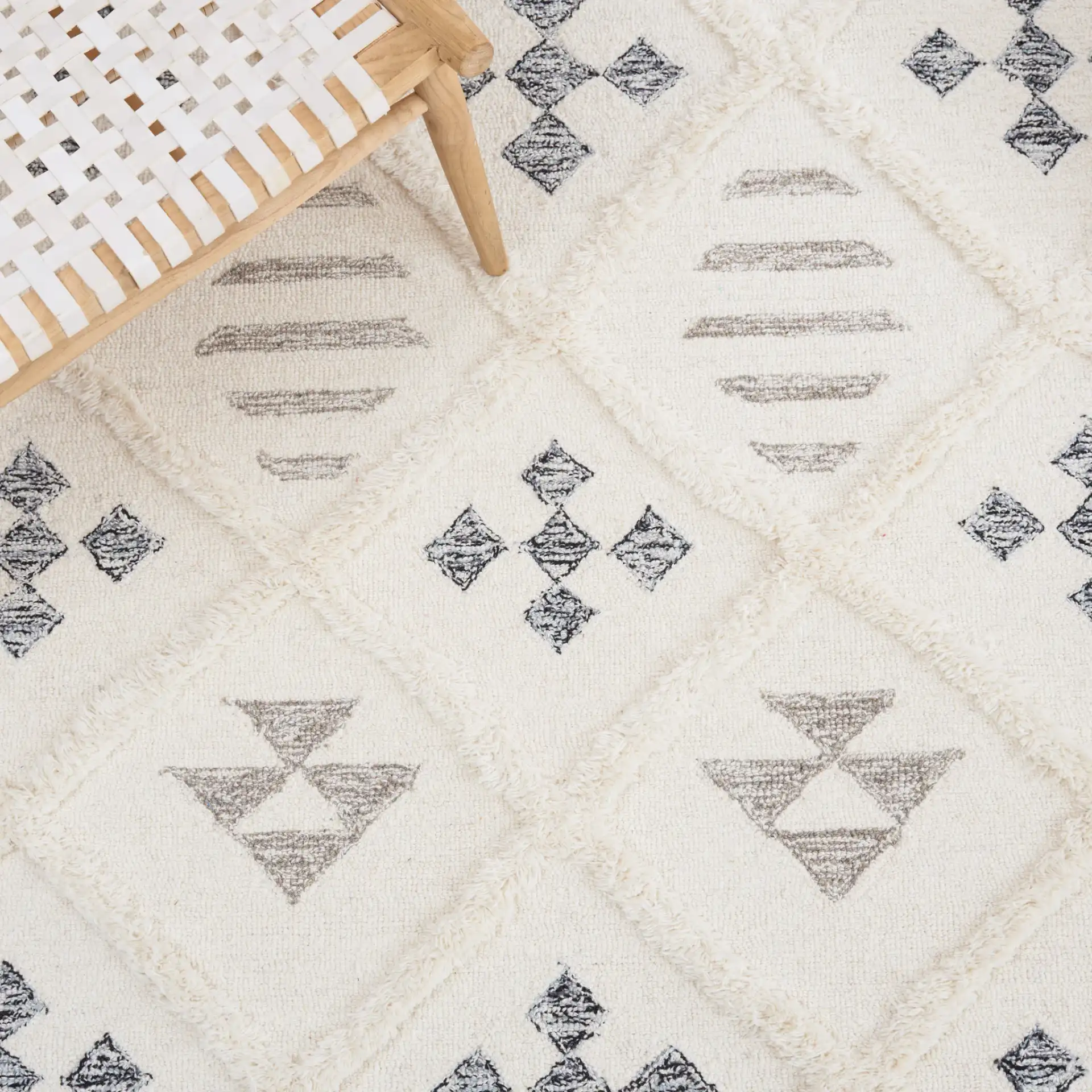 Casablanca Tribal Motif Trellis Hand-Tufted Wool Rug in Ivory / Black in a styled room