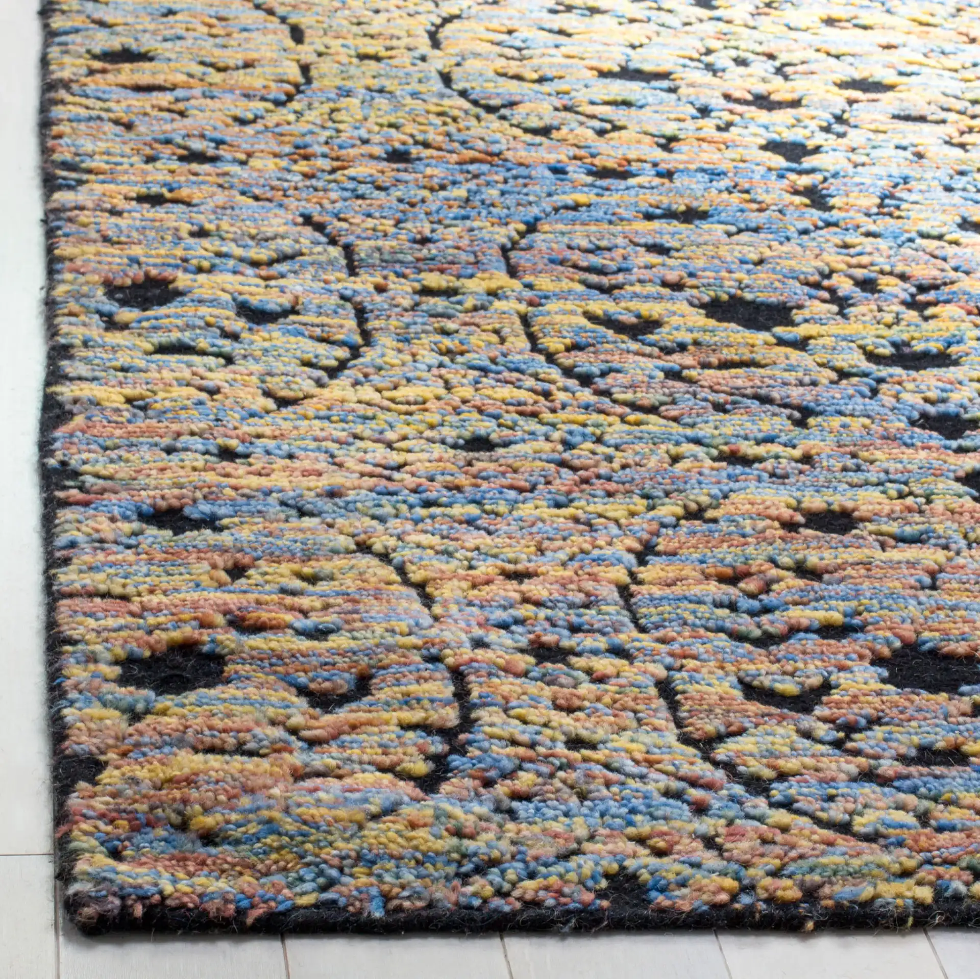 Castilla Repeating Medallion Hand-Knotted Wool Rug in Blue Gold / Charcoal in a styled room