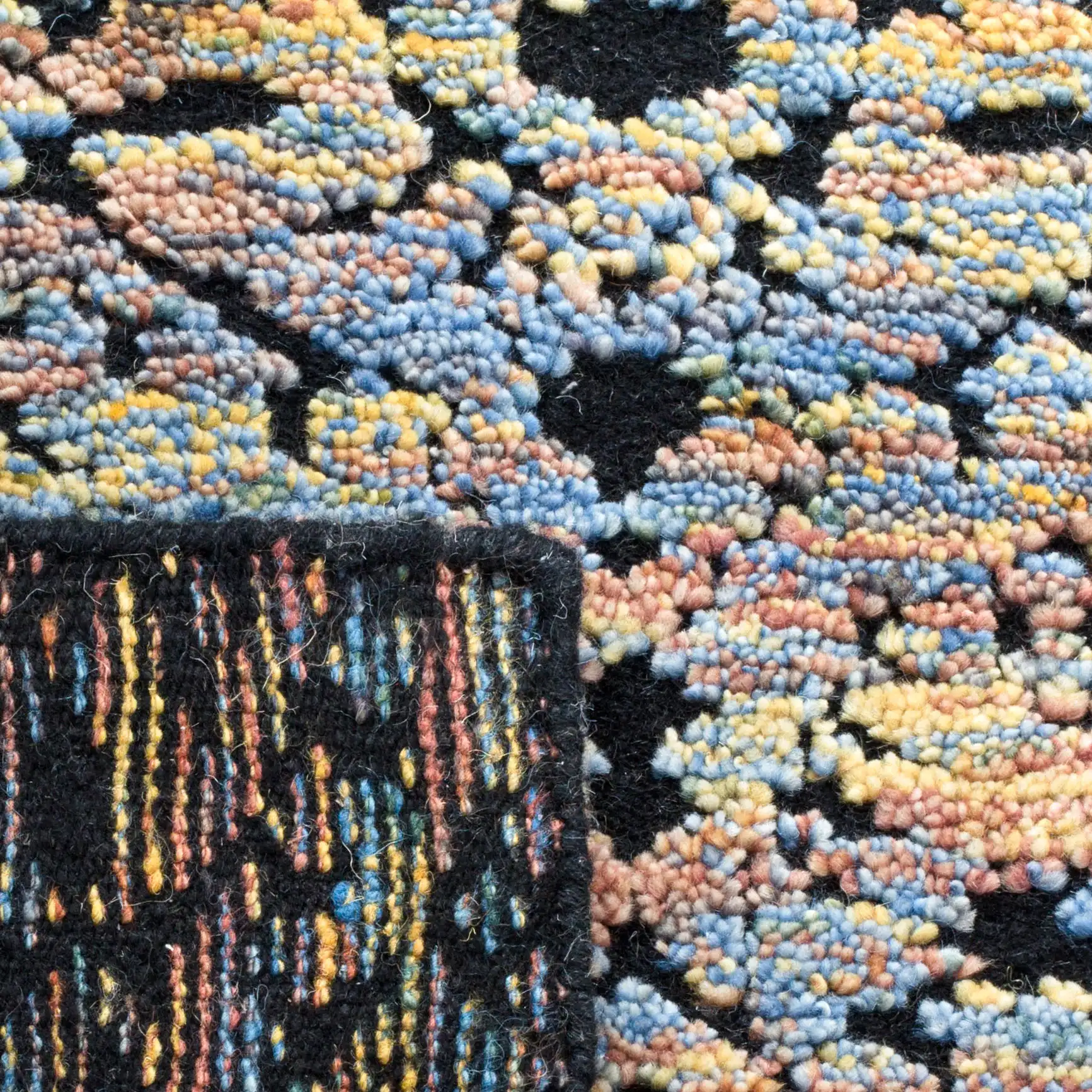 Castilla Repeating Medallion Hand-Knotted Wool Rug in Blue Gold / Charcoal in a styled room