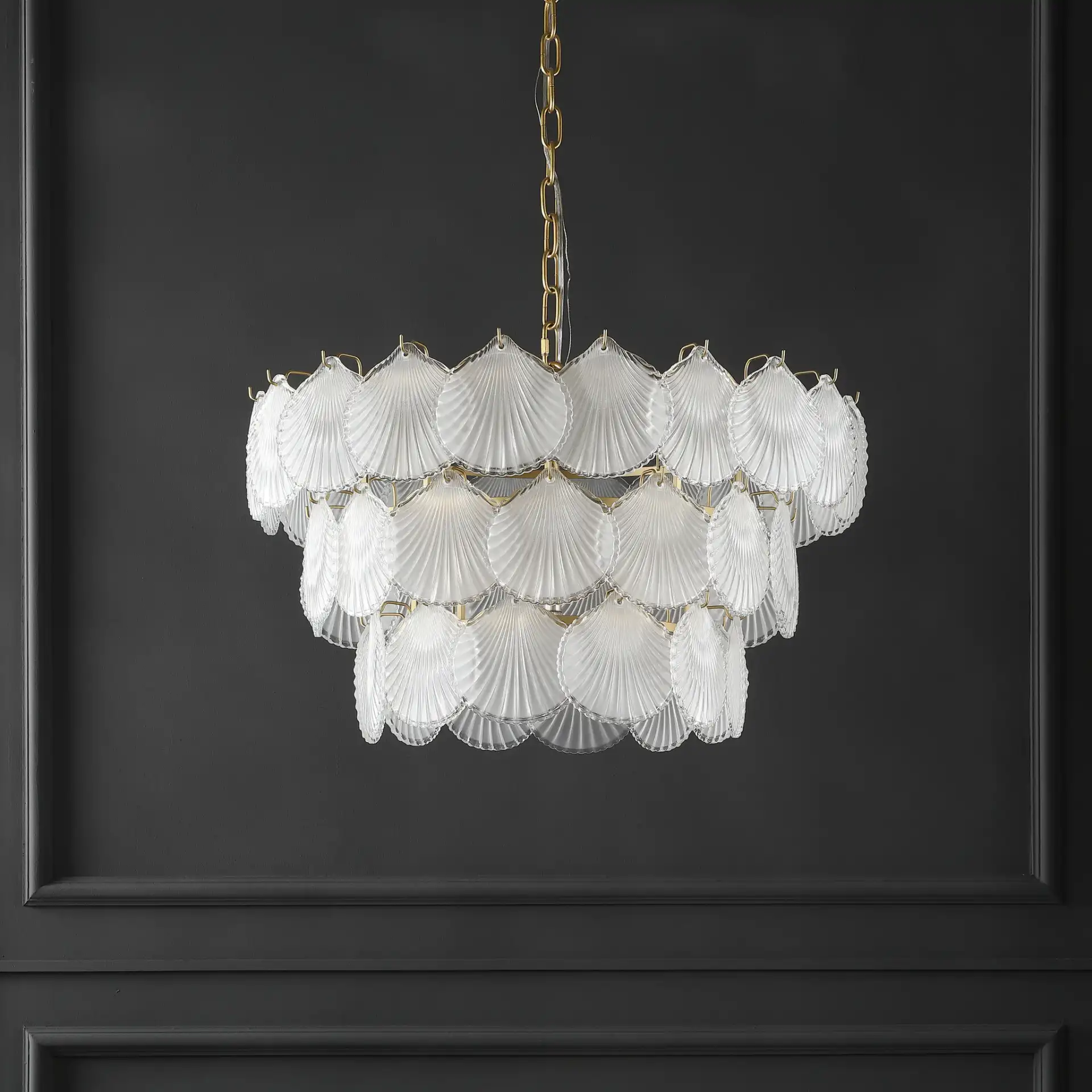 Gutierrez Three-Tier Glass Chandelier in Gold in a styled room