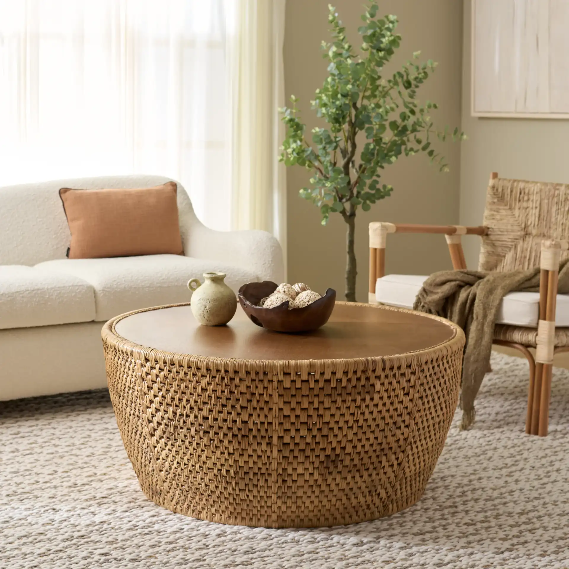 Braylen Rattan Round Coffee Table in Natural in a styled room