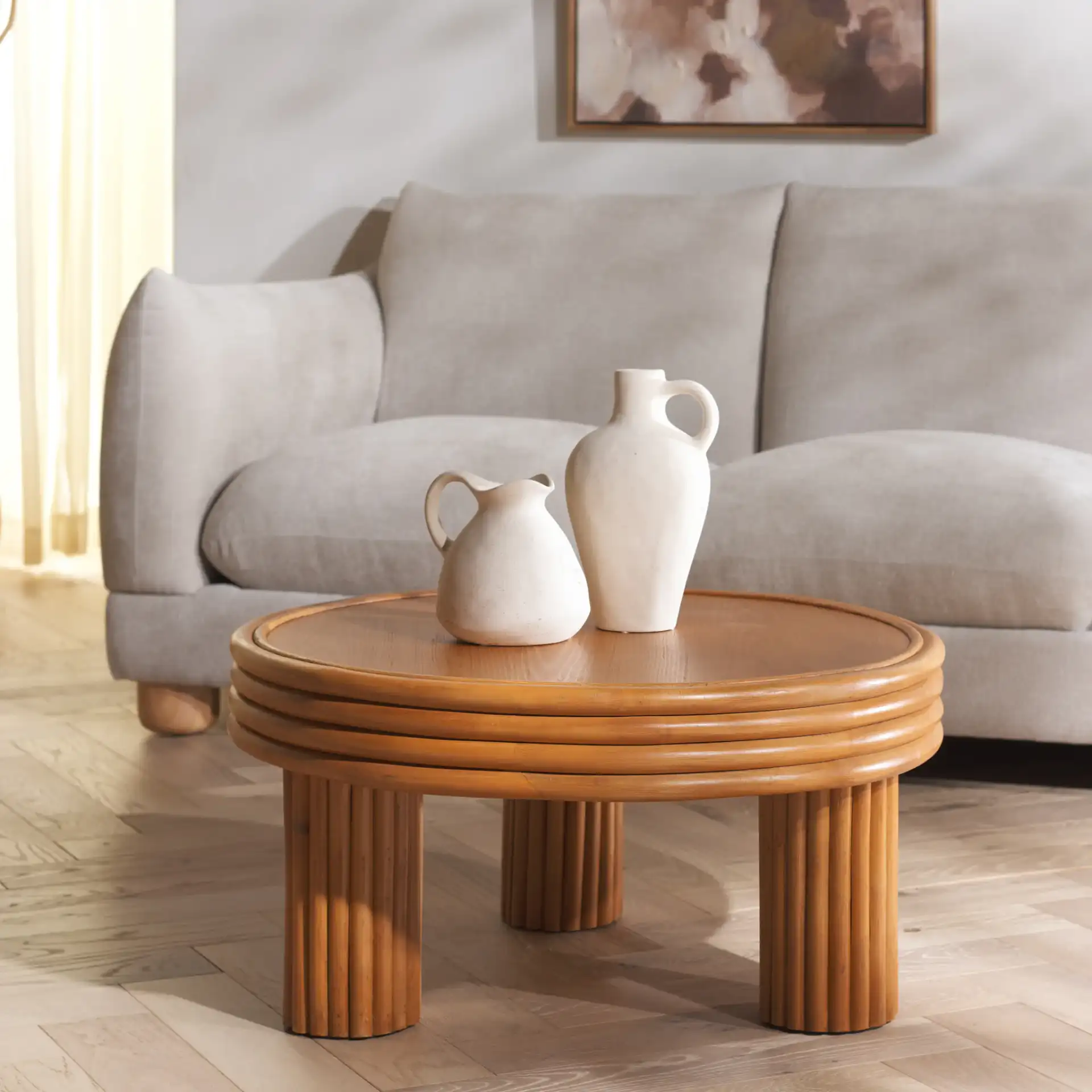 Bayard Rattan Round Coffee Table in Natural in a styled room