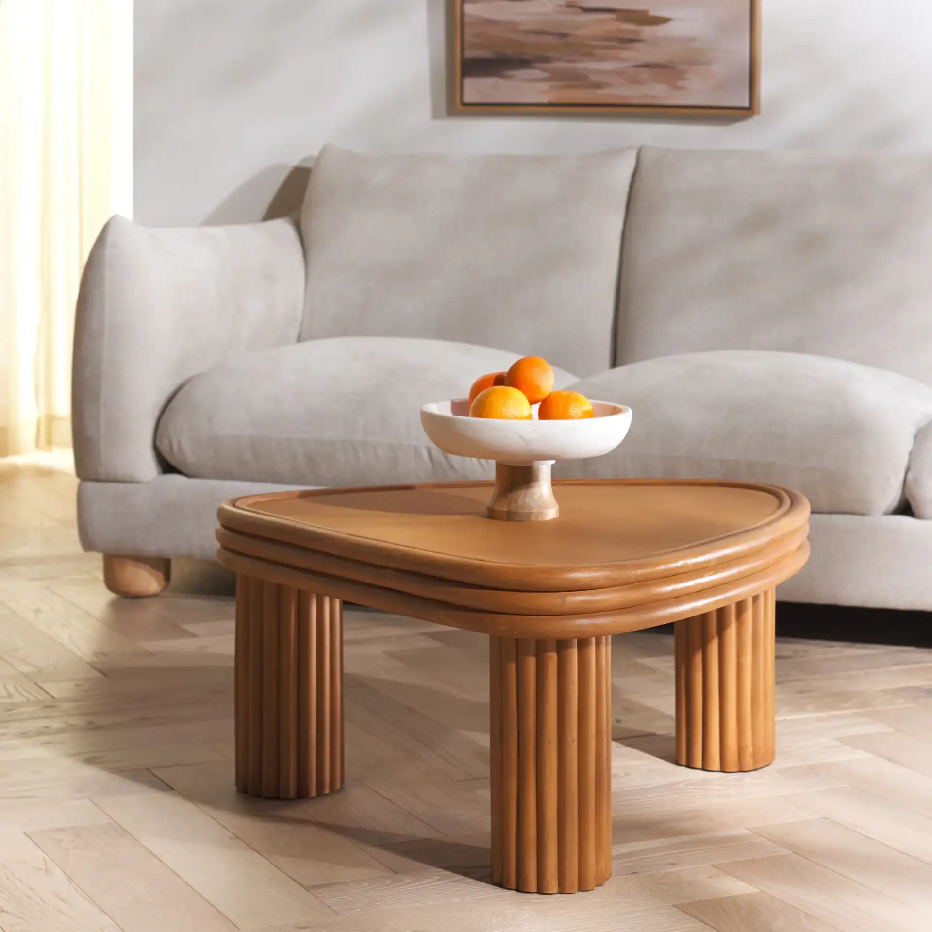 Bayard Rattan Triangle Coffee Table in Natural in a styled room