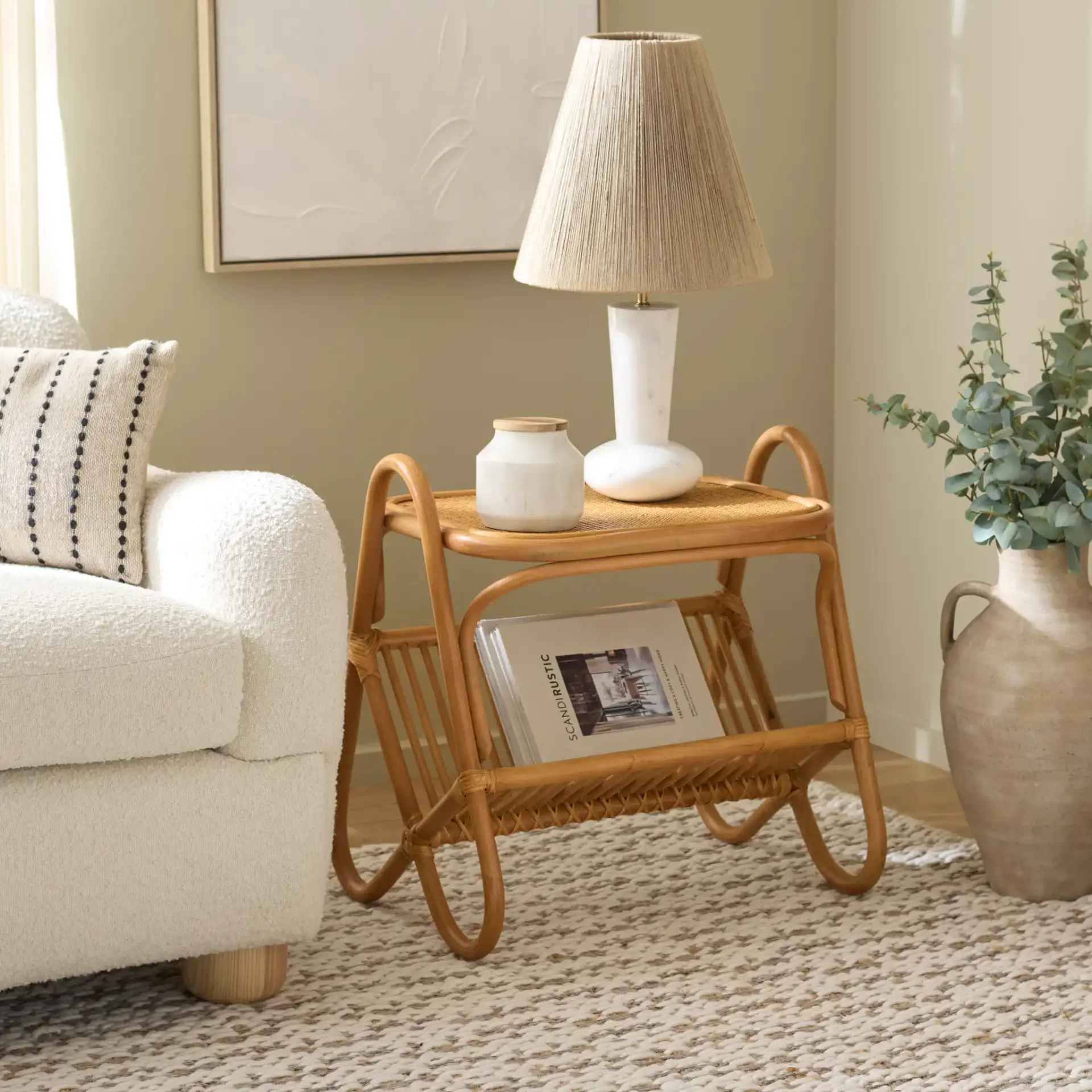 Bayard Rattan Pole Accent Table in Natural in a styled room