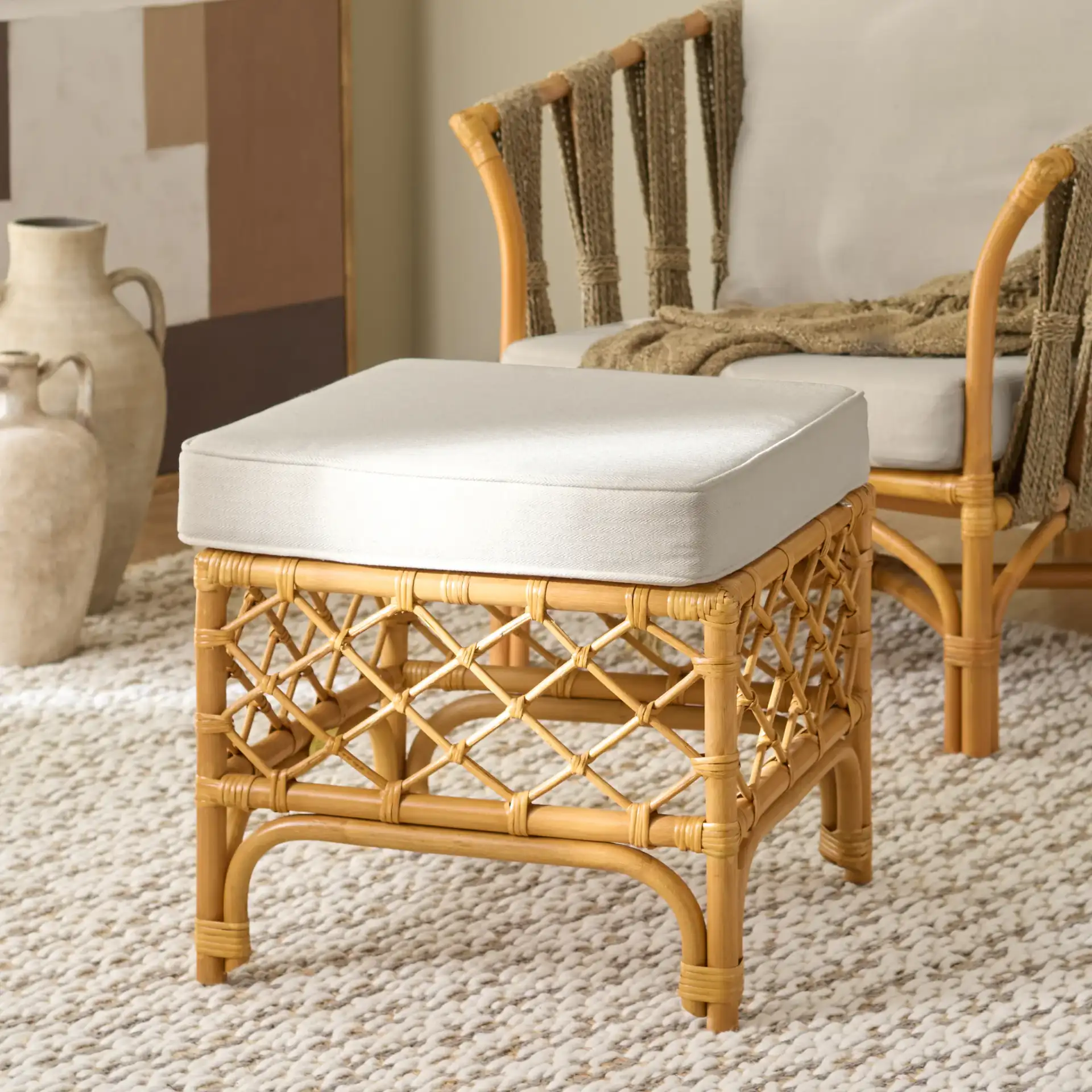 Cherilynn Rattan Pole Ottoman in Natural / White in a styled room