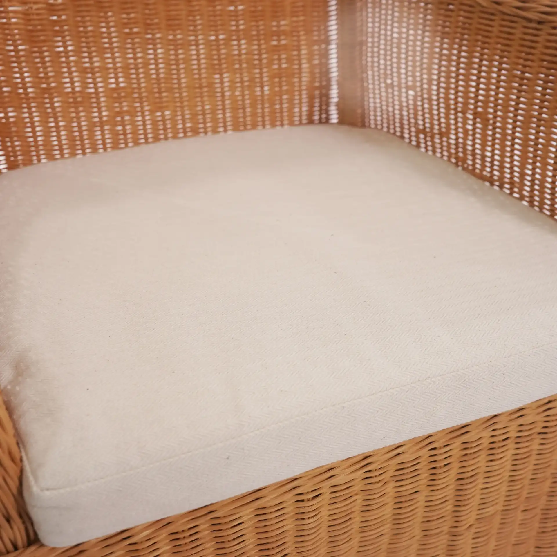 Hylda Rattan Dining Chair in Natural / White in a styled room