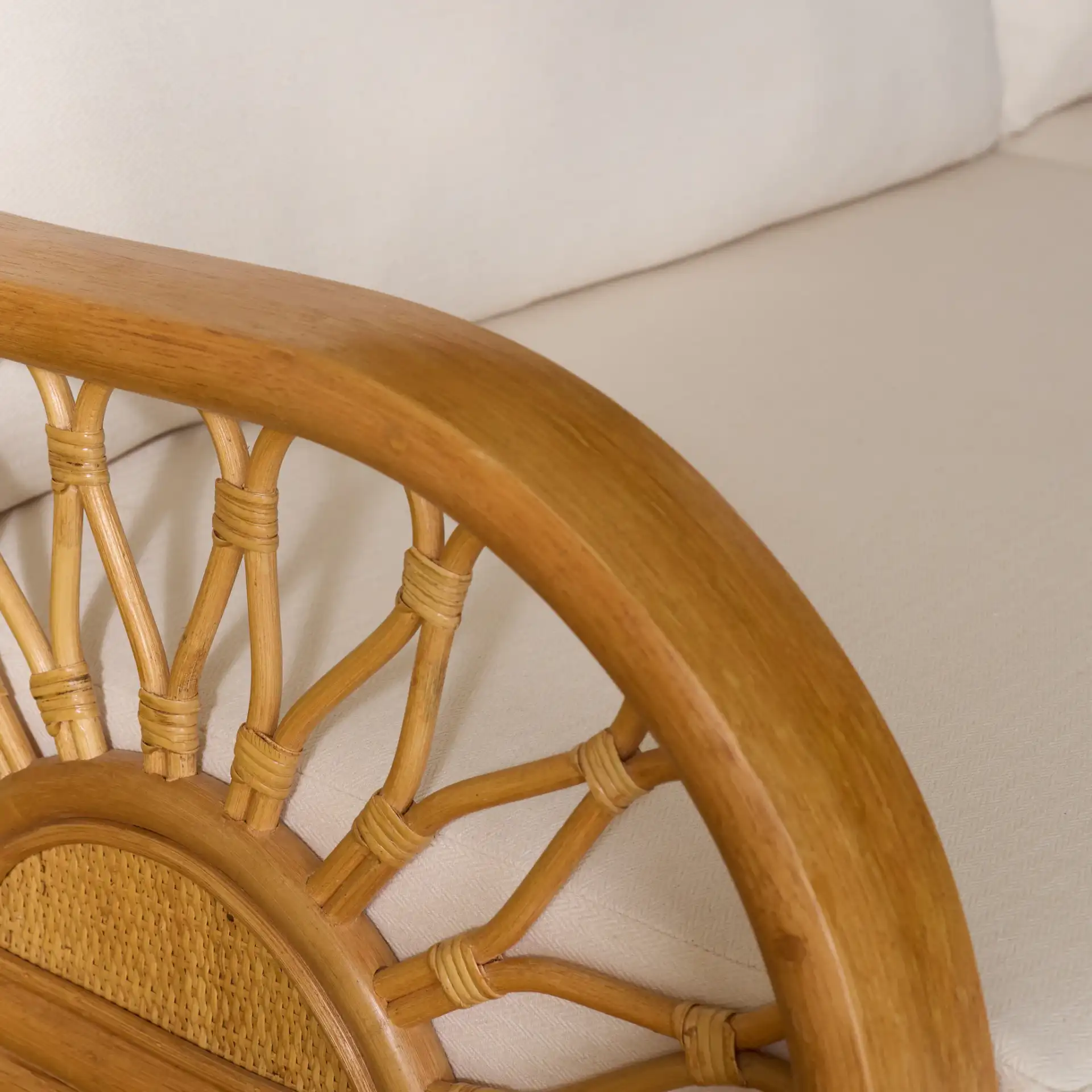 Isaias Rattan Loveseat in Natural in a styled room