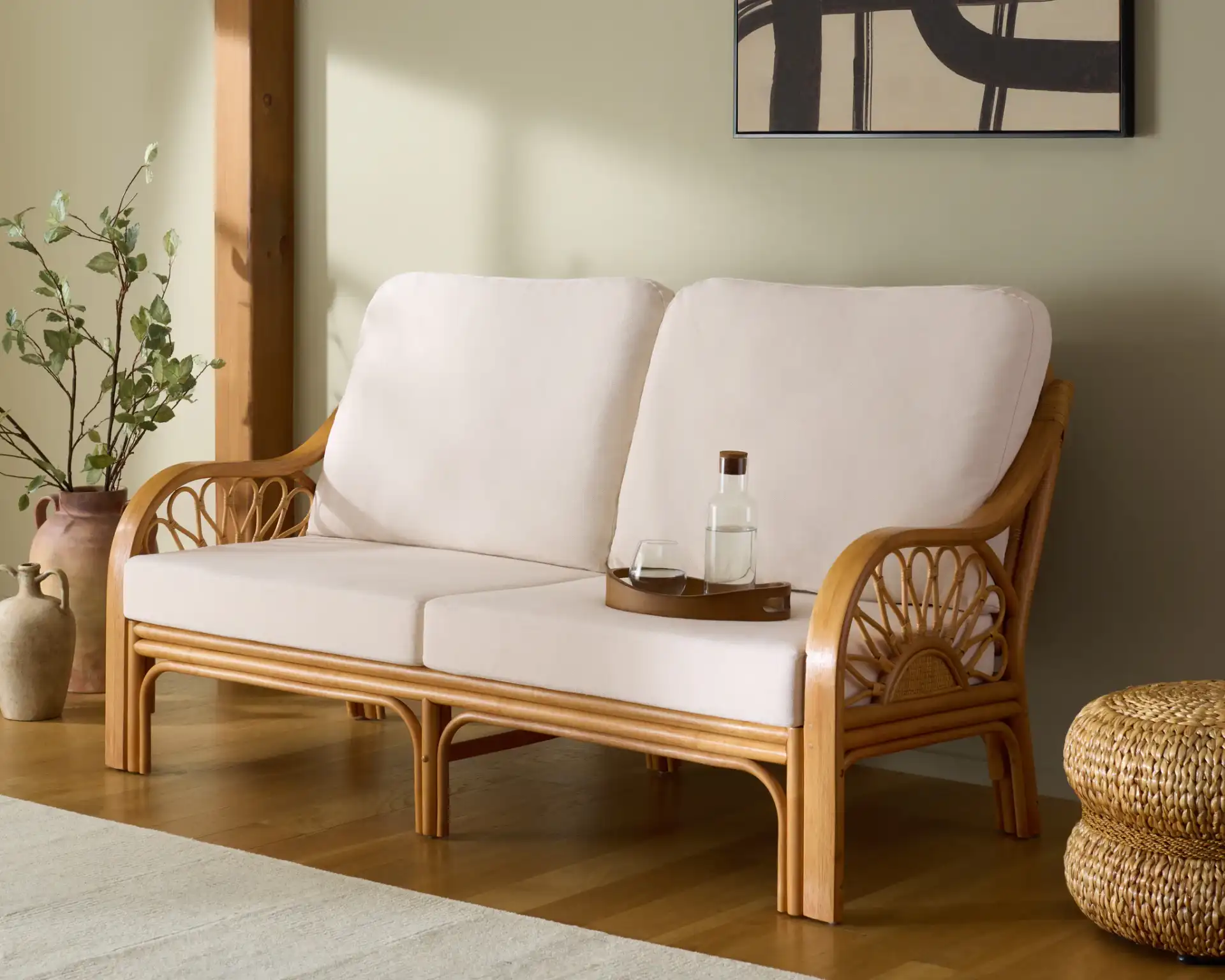 Isaias Rattan Loveseat in Natural in a styled room