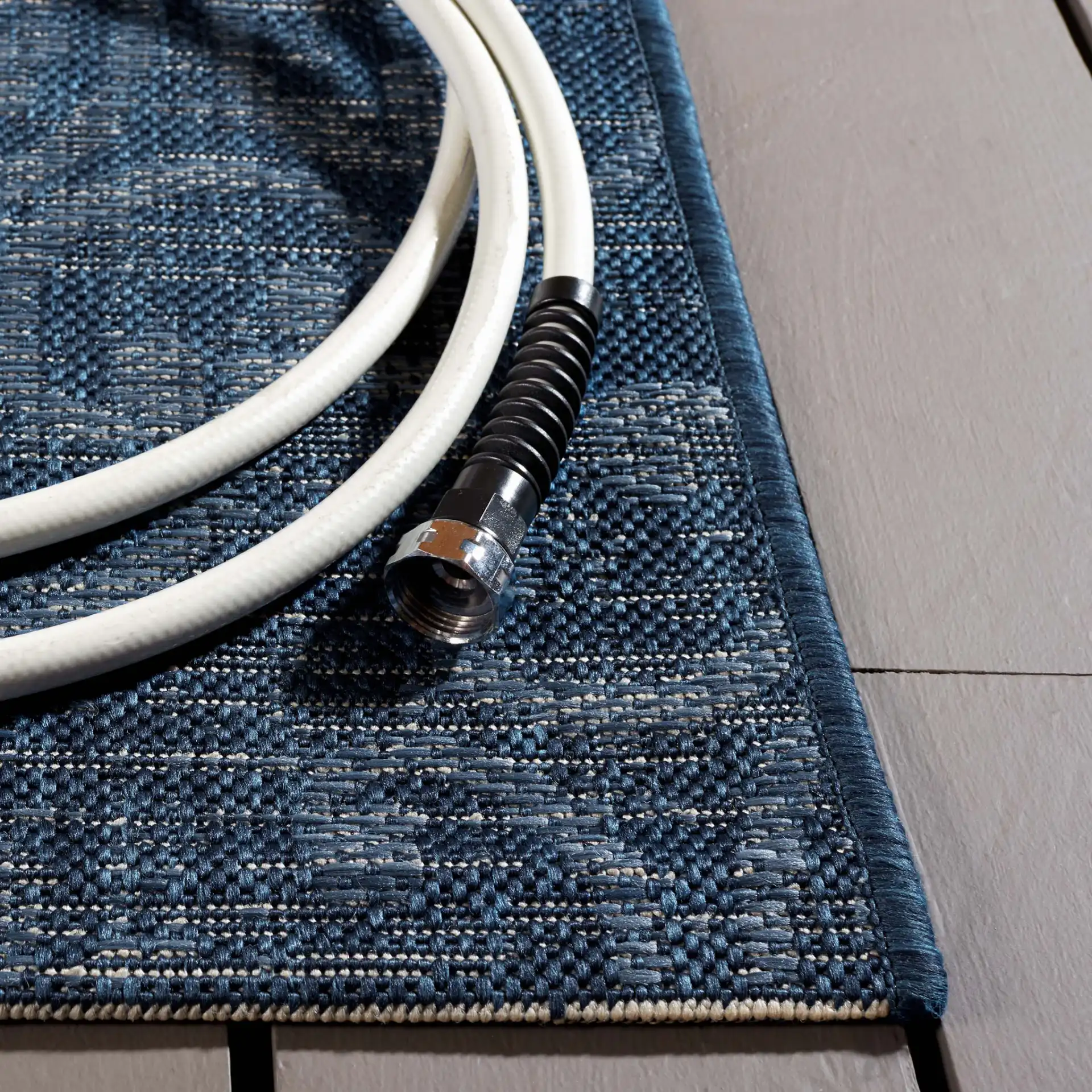 Courtyard Medallion Tile Outdoor Rug in Navy / Beige in a styled room