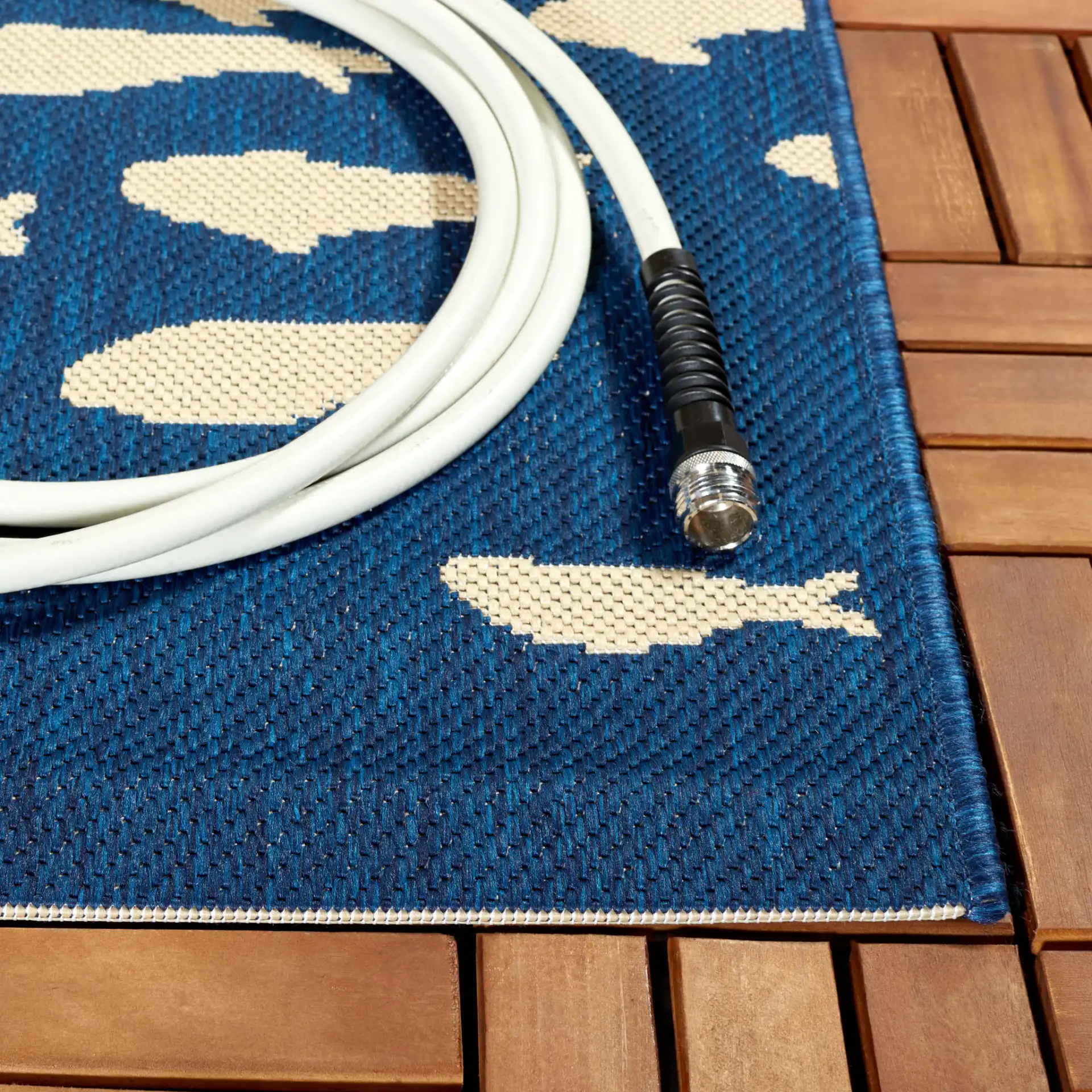 Courtyard School Of Fish Outdoor Rug in Navy / Beige in a styled room